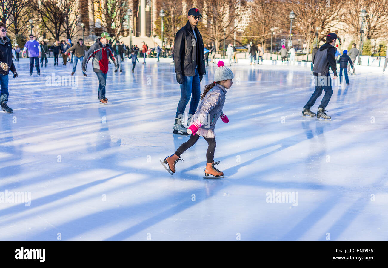 Washington DC, USA - January 28, 2017: Young girl skating in ice rink in National Gallery of Art Sculpture garden Stock Photo