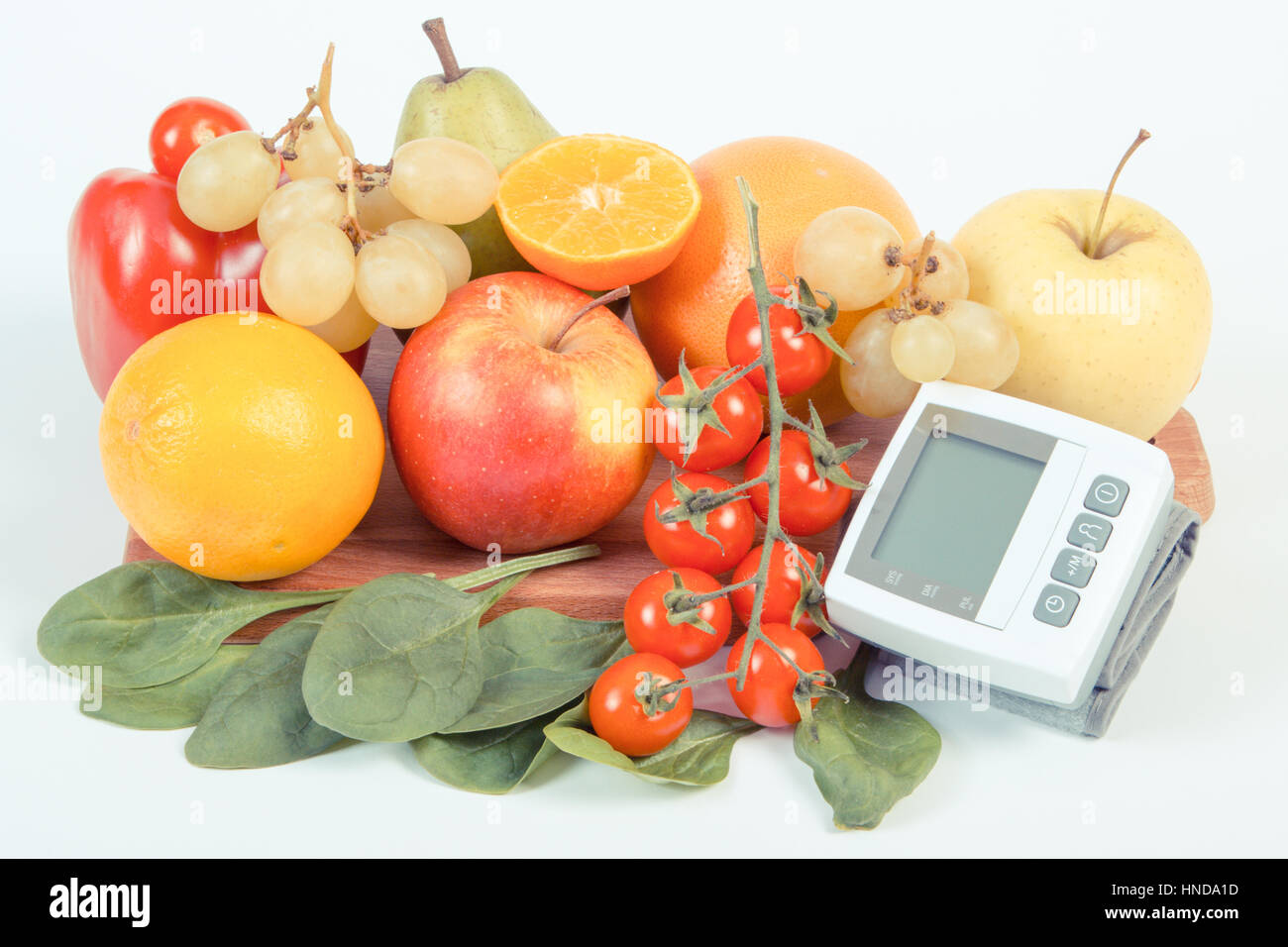 Vintage photo, Blood pressure monitor and fresh fruits with vegetables ...