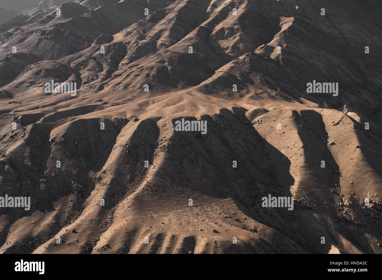 Arid landscape mountain texture with sunny and shadow Stock Photo