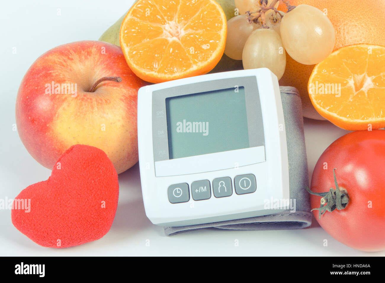 Vintage photo, Blood pressure monitor and fresh fruits with vegetables ...