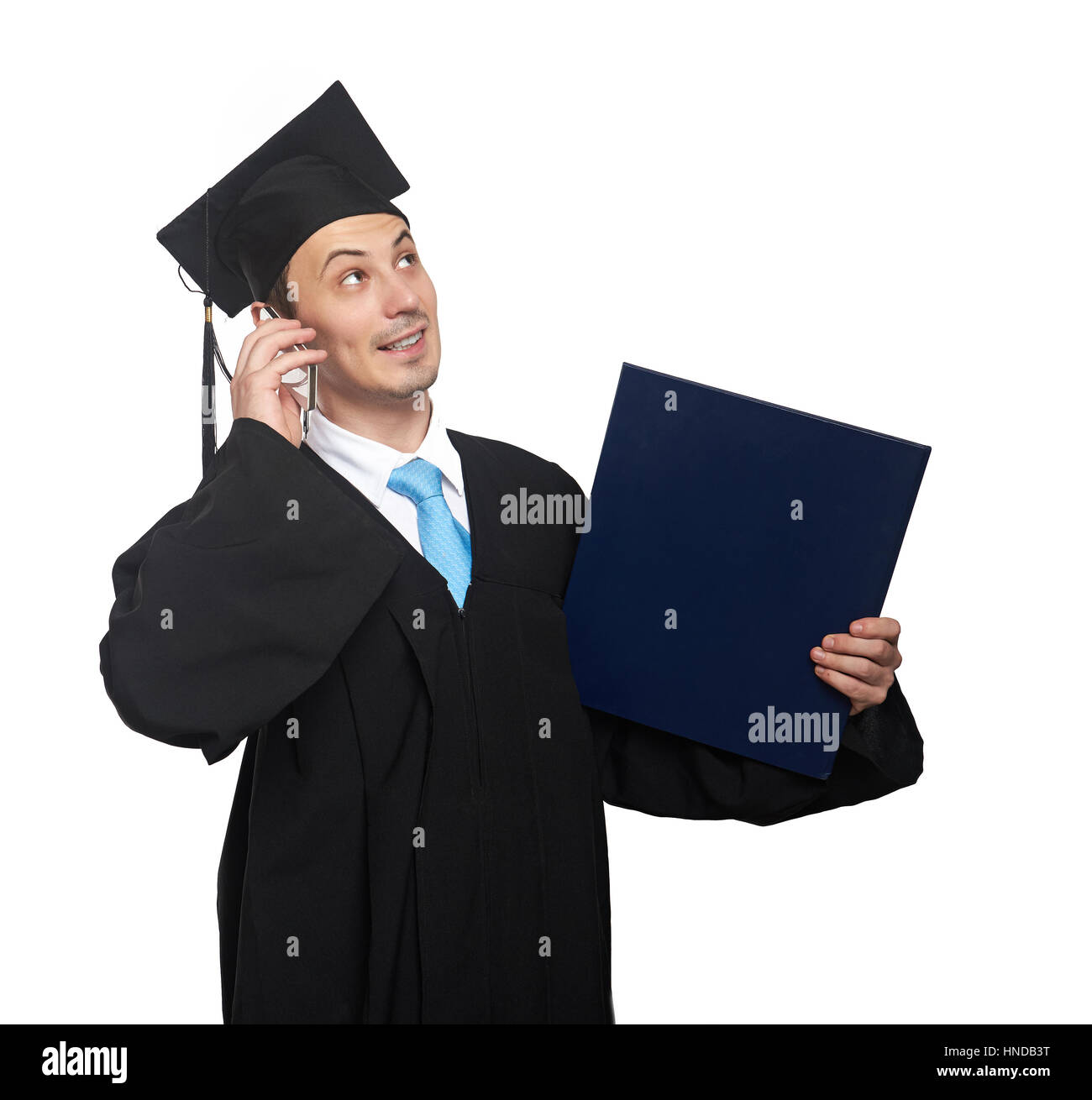Graduating student talk on smartphone isolated on white background Stock Photo