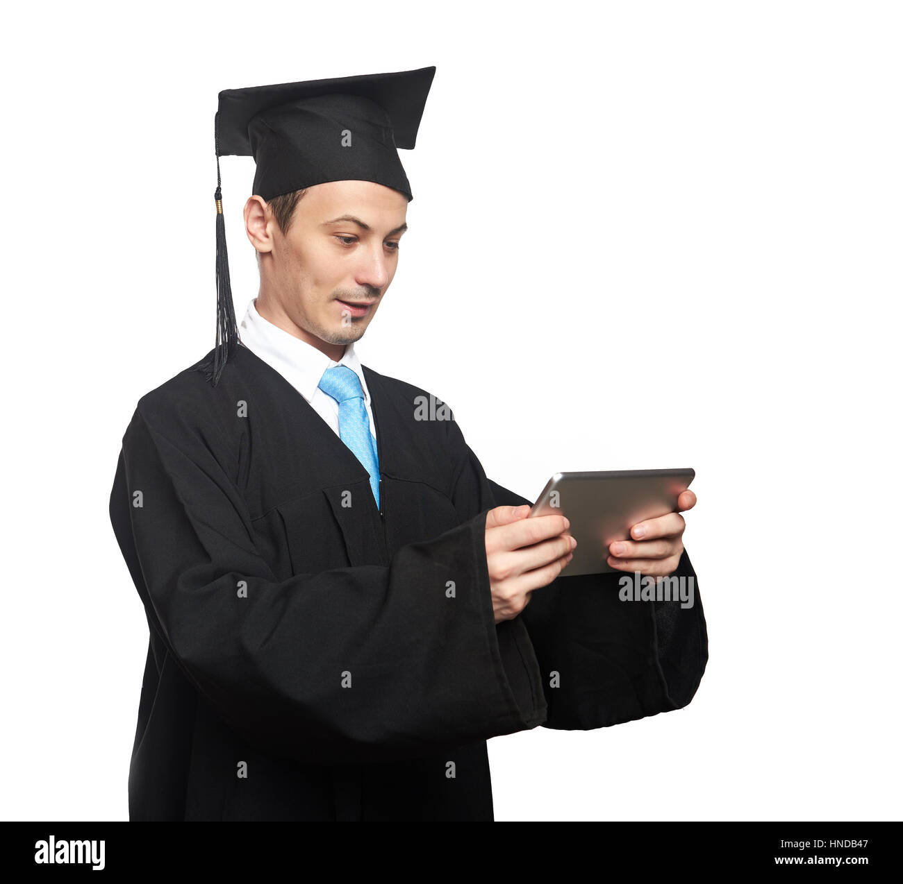 Graduation student with tablet isolated on white background Stock Photo