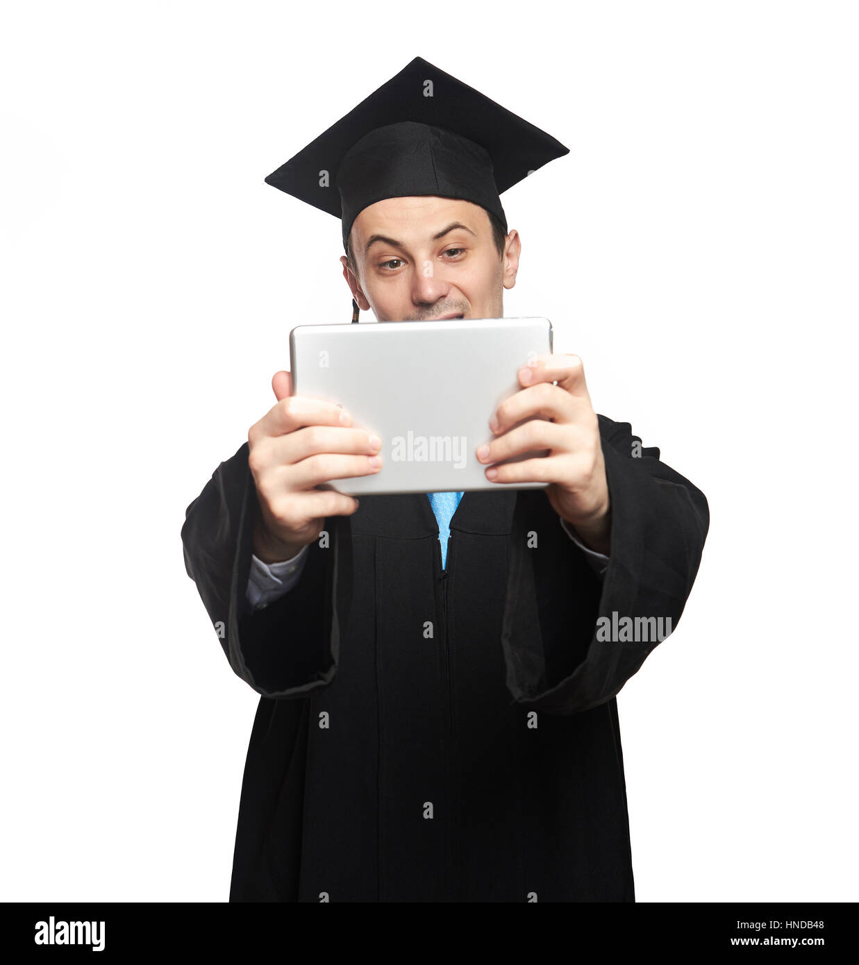 Graduated student look at tablet isoalted on white backgorund Stock Photo