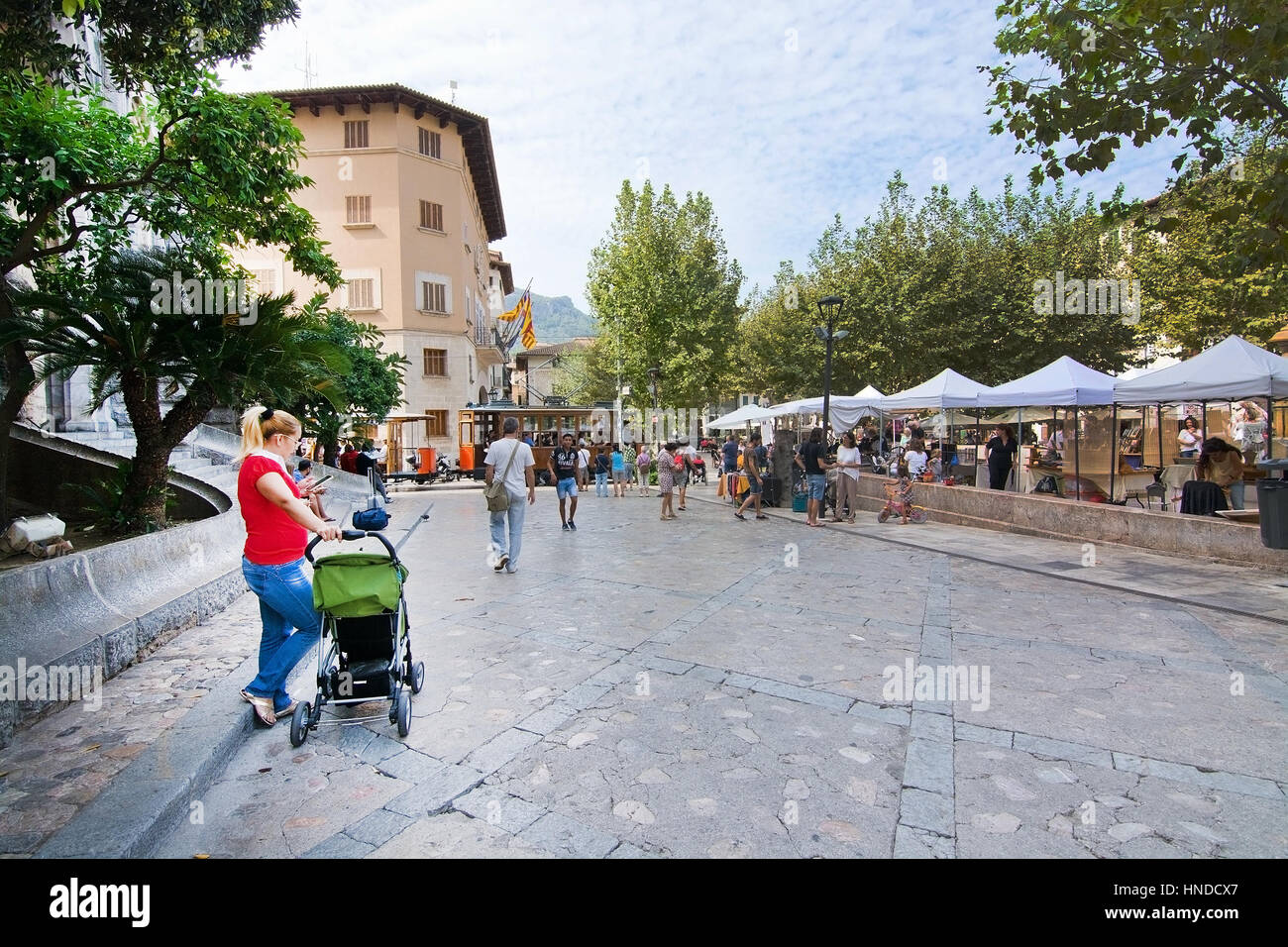 SOLLER, MALLORCA, SPAIN - OCTOBER 2, 2016: Church square with market, tourists and tram on a sunny day on October 2, 2016 in Soller, Mallorca, Baleari Stock Photo