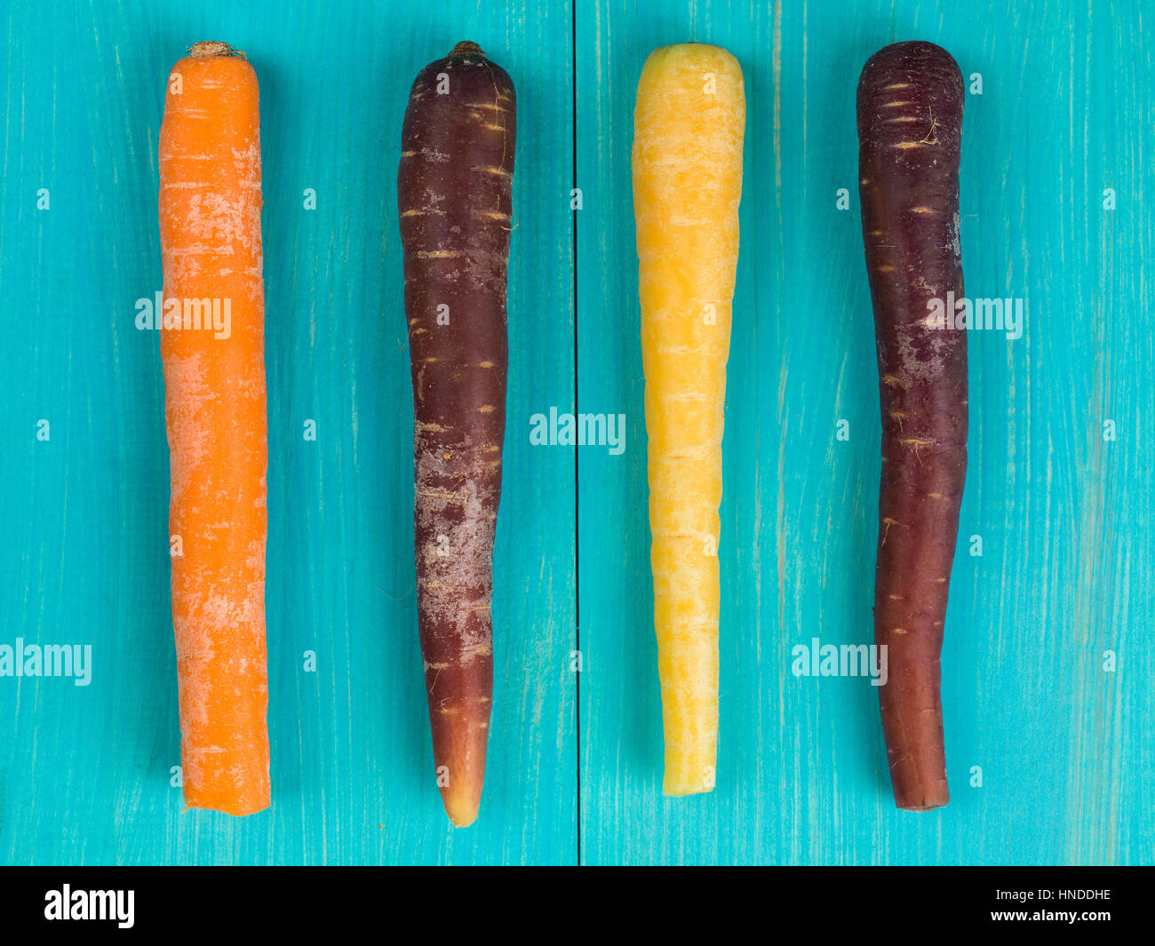 Colorful Rainbow Carrots Cooking Ingredients On A Blue Background Stock Photo