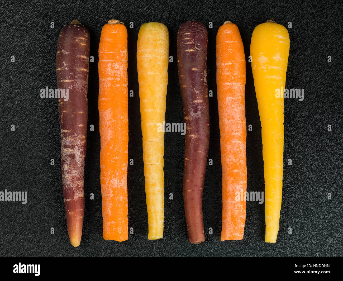 Colorful Rainbow Carrots Cooking Ingredients On A Black Background Stock Photo