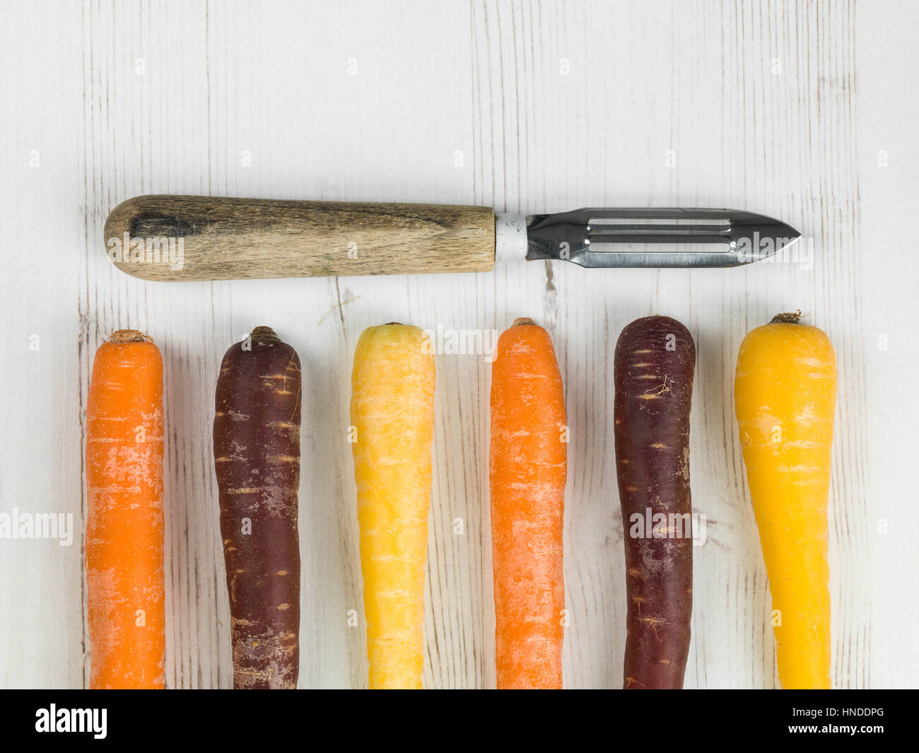 Colorful Rainbow Carrots Cooking Ingredients With A Vegetable Peeler Stock Photo