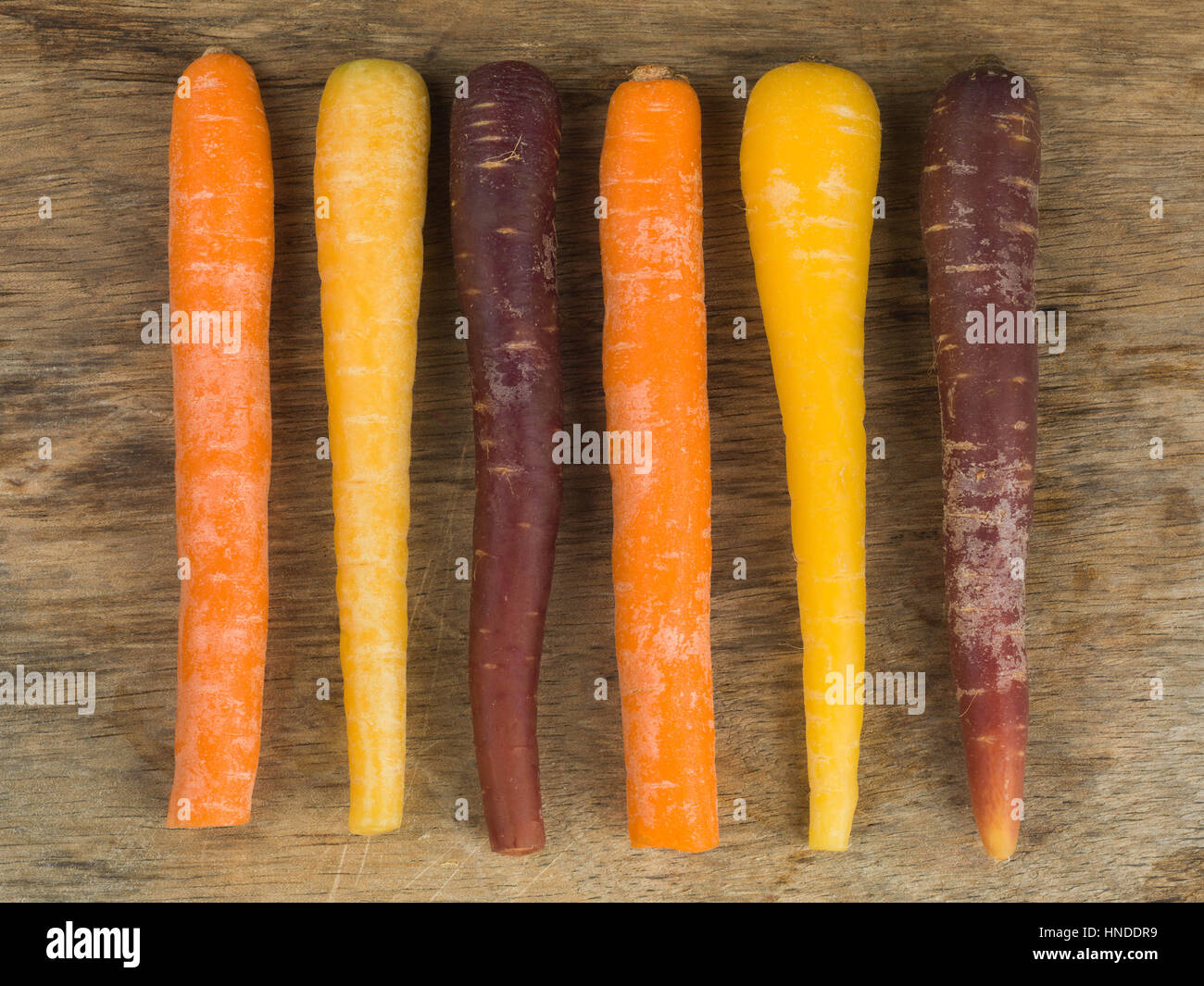 Colorful Rainbow Carrots Cooking Ingredients On A Natural Wood Background Stock Photo