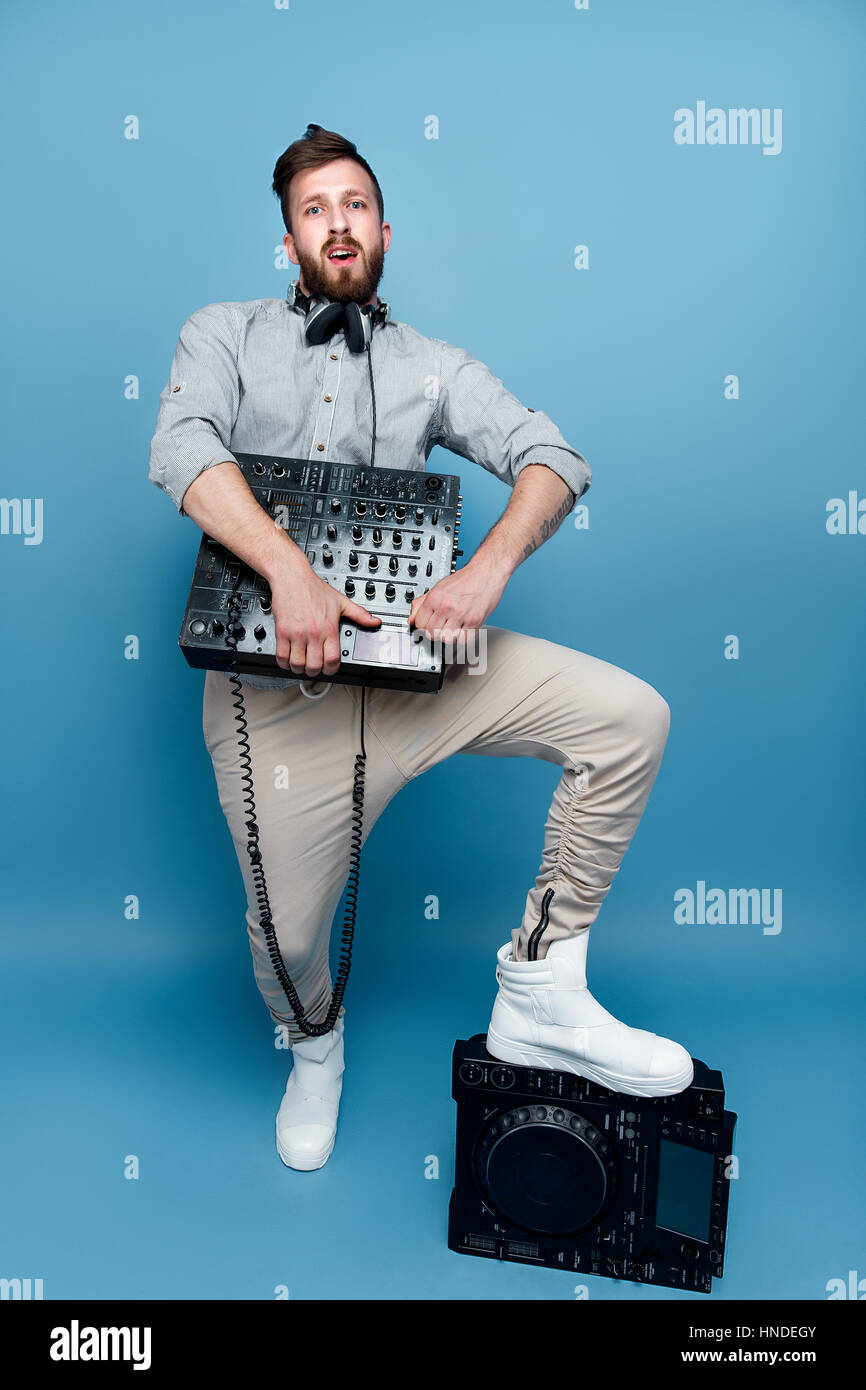 Young male holding mixing console Stock Photo - Alamy