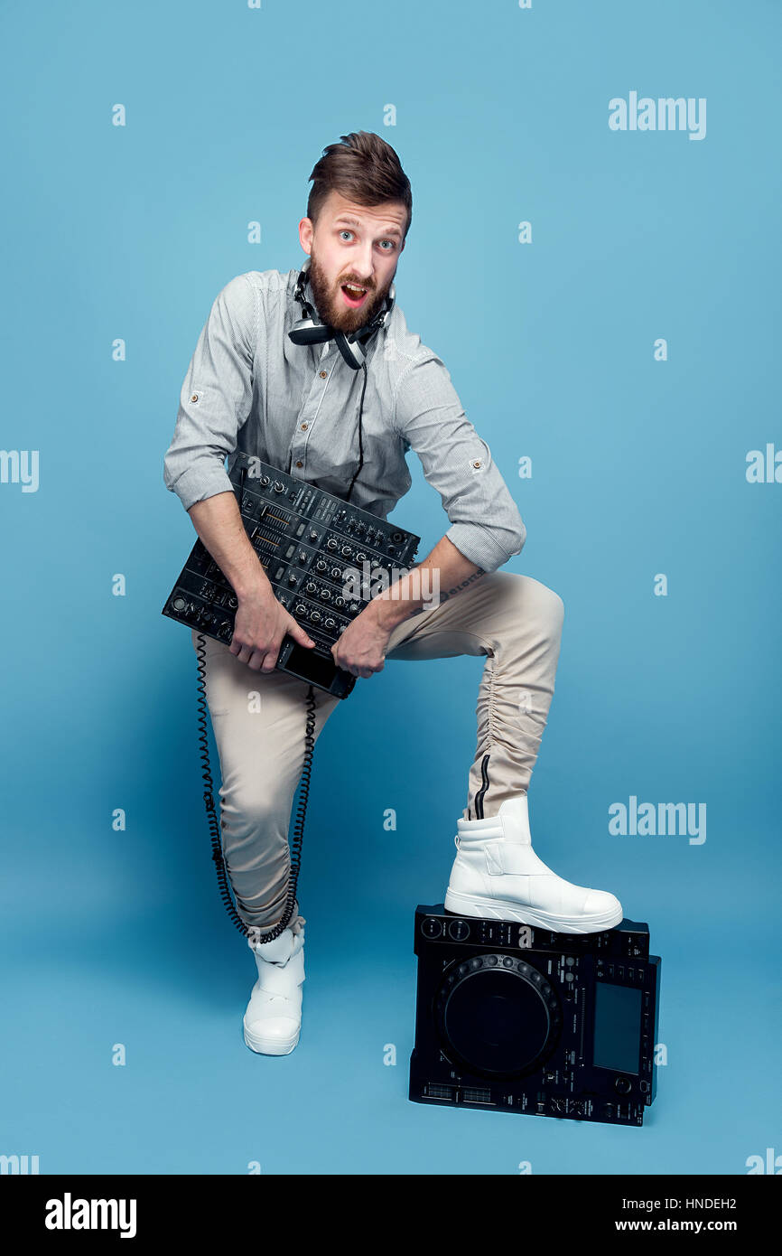 Young male holding mixing console Stock Photo - Alamy