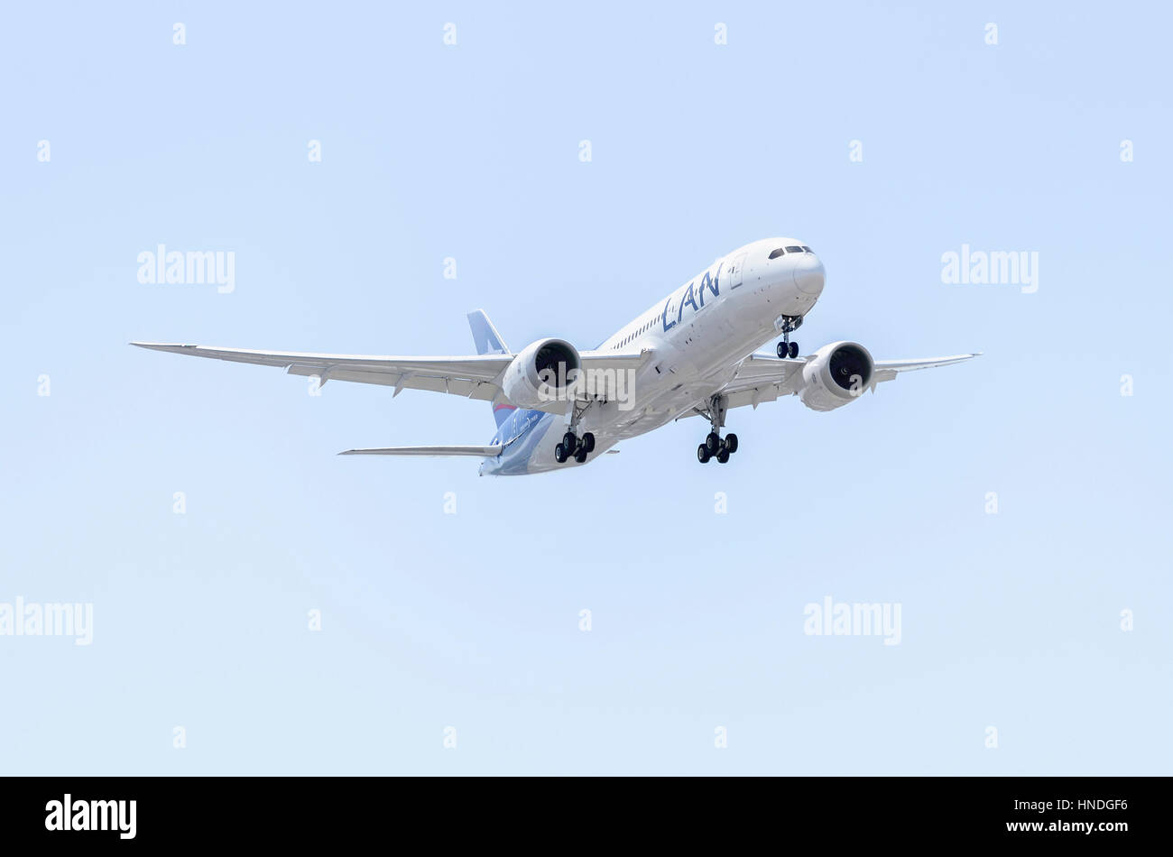 Plane Boeing 787 Dreamliner, of LAN Airlines airline, is landing. Latin America's largest airline. Blue sky. Sunny day of spring. Stock Photo