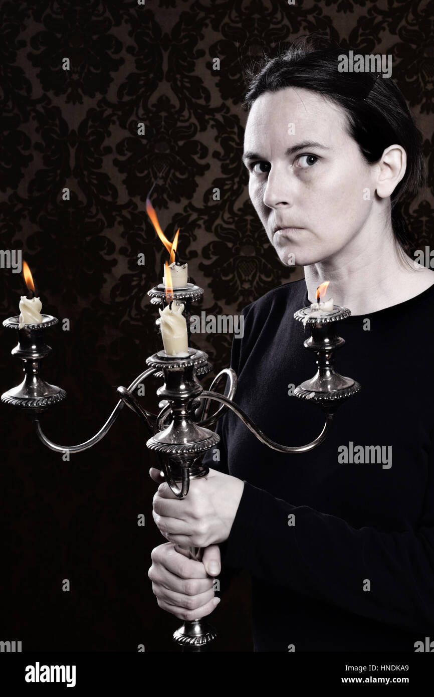 Scary woman with a candelabra Stock Photo Alamy