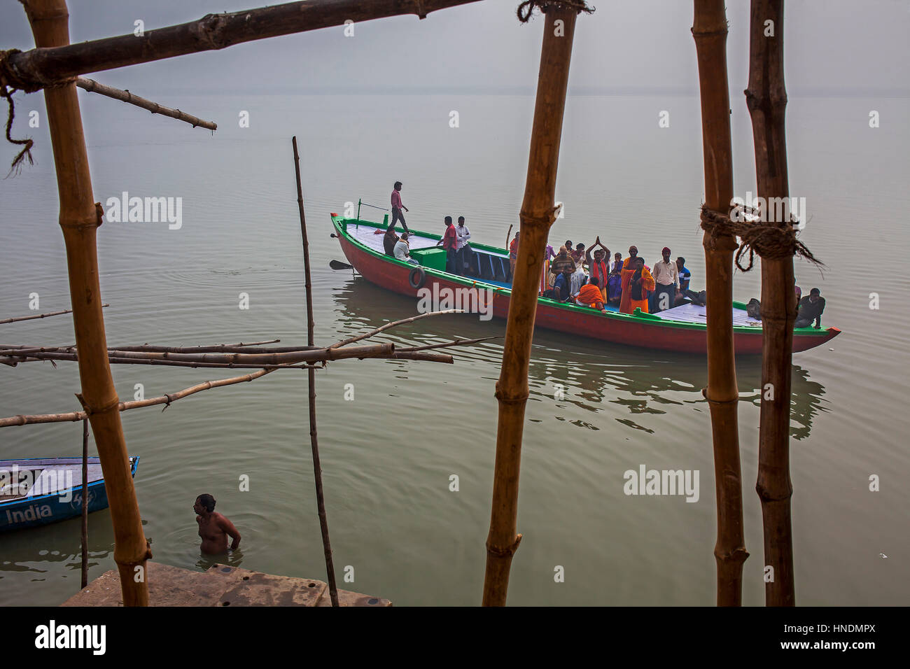 Panorama, panoramic, Pilgrims in a boat sailing and praying, in Ganges river, Varanasi, Uttar Pradesh, India. Stock Photo