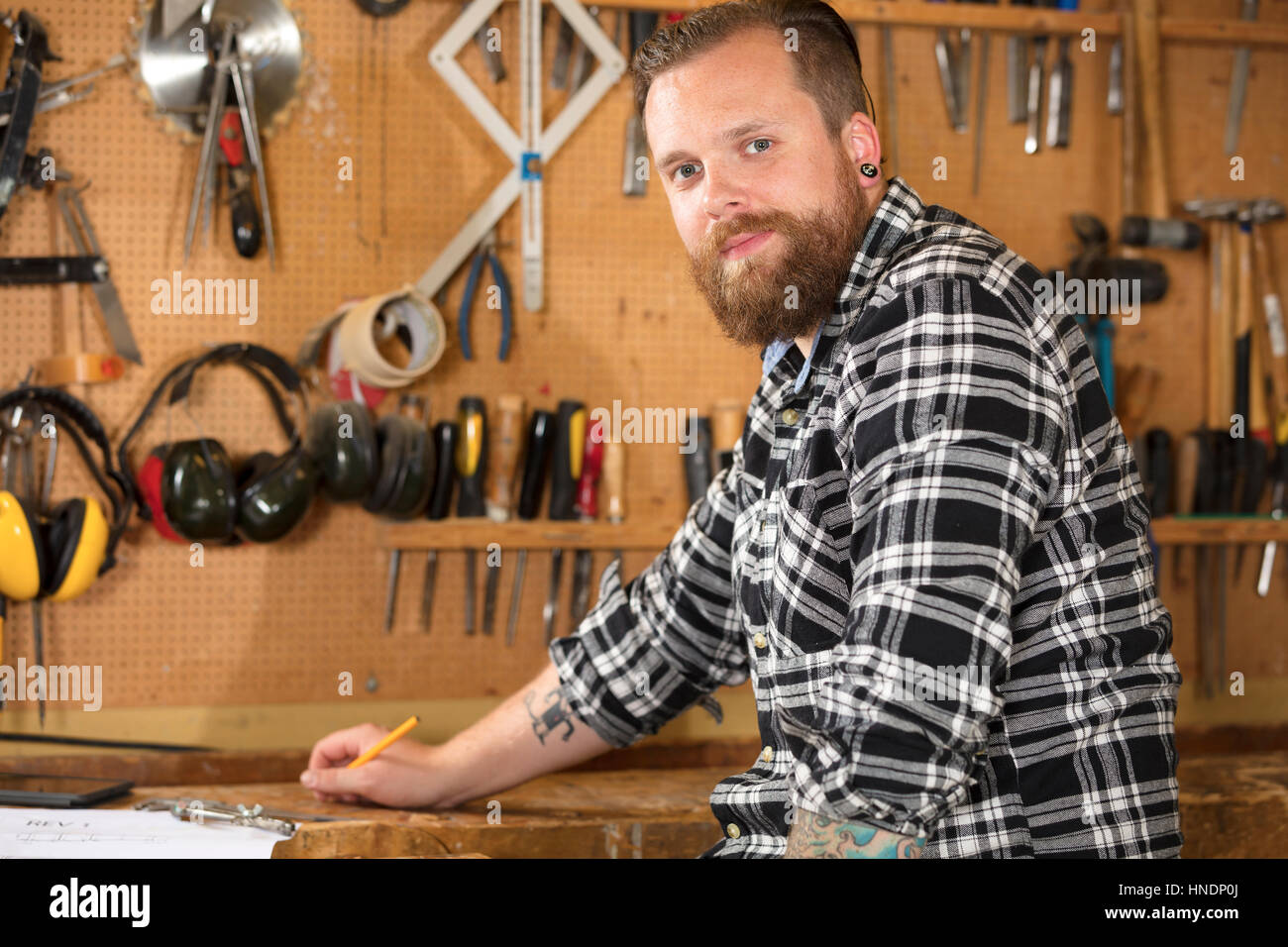 Environmental portrait of a carpenter in workshop Stock Photo