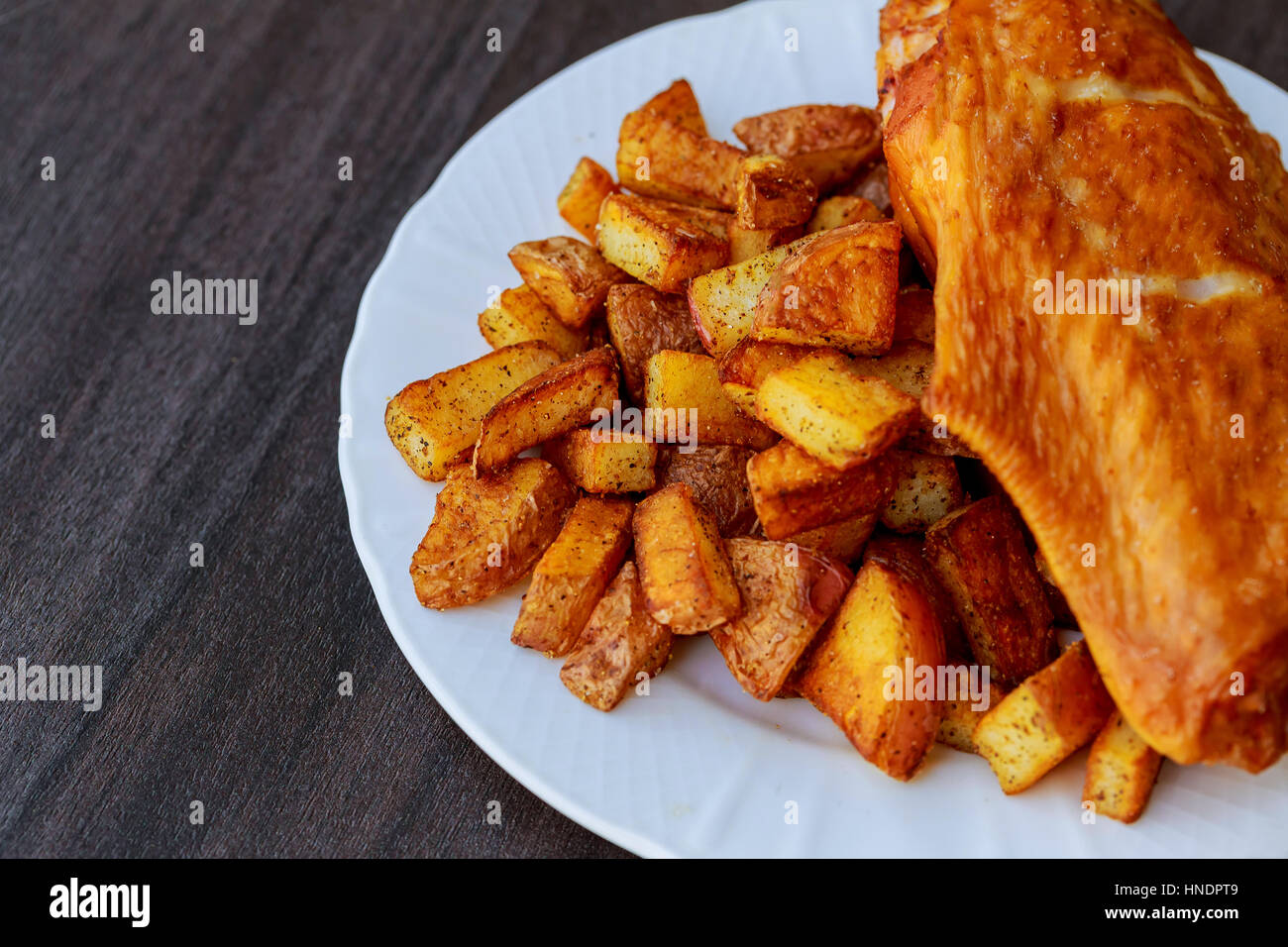 Fried chicken wings with potato on black stone Stock Photo Alamy