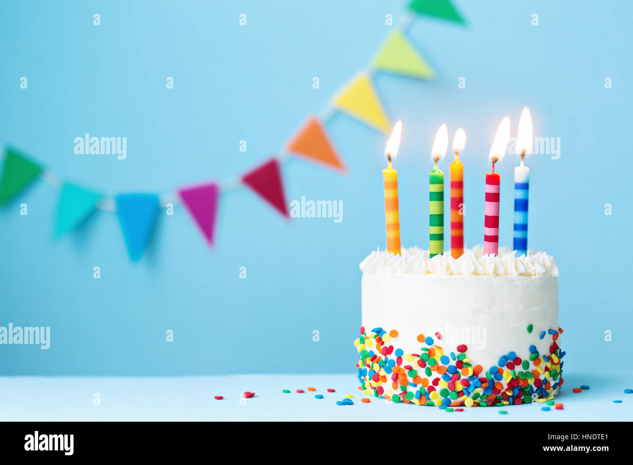 Birthday cake with colorful candles Stock Photo - Alamy