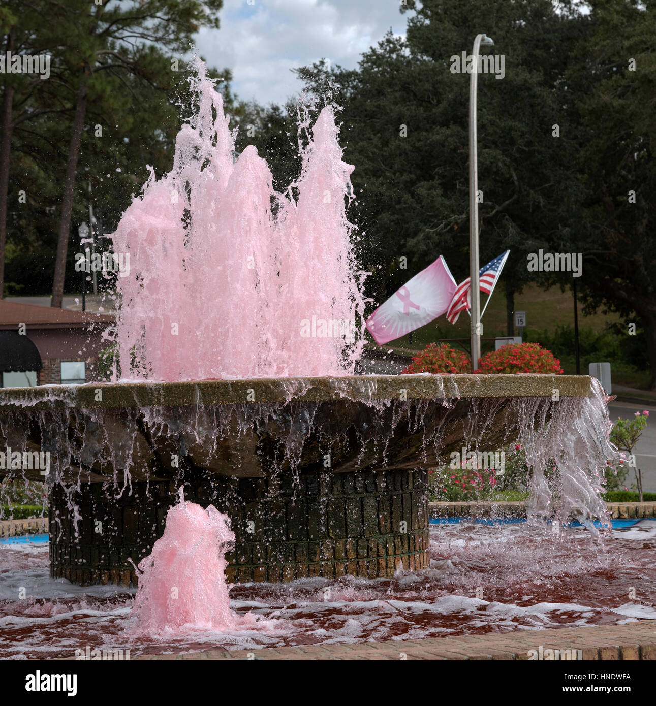 Fairhope Pier Fountain with pink colored water in support of Cancer Awareness in Alabama USA Stock Photo