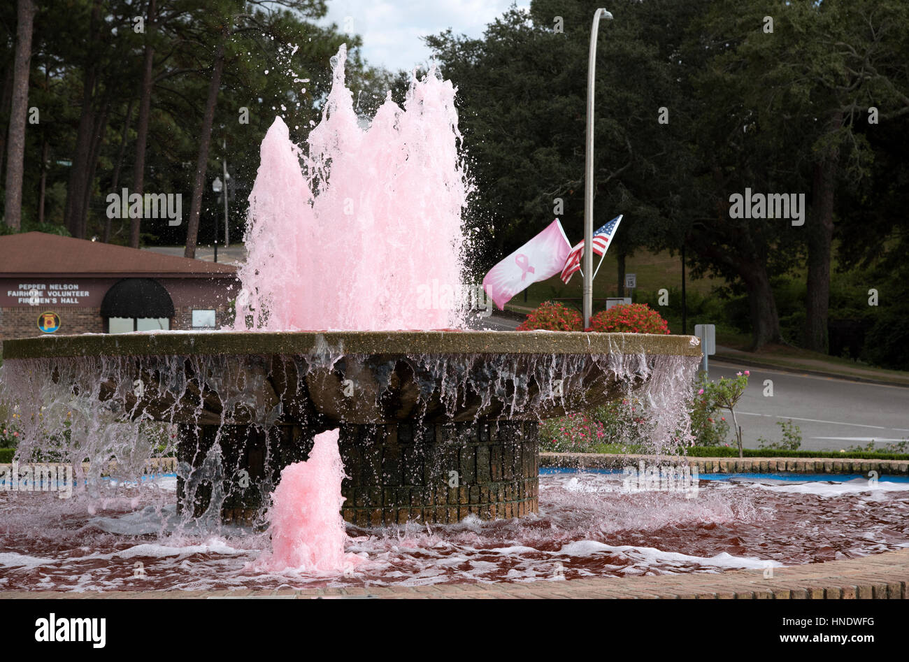 Fairhope Pier Fountain with pink colored water in support of Cancer Awareness in Alabama USA Stock Photo