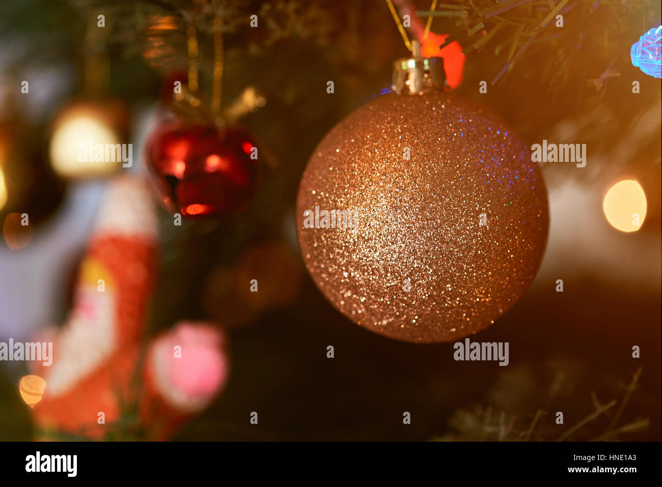 Sparkle gold sphere close up on christmas tree Stock Photo