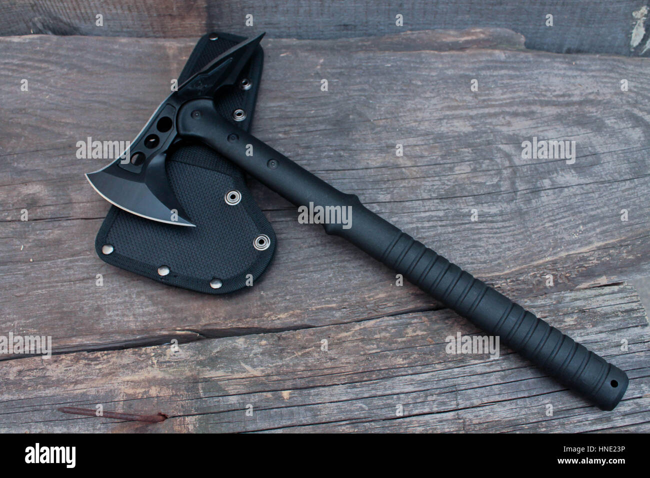 Army axe. Black axe on wood background Stock Photo - Alamy