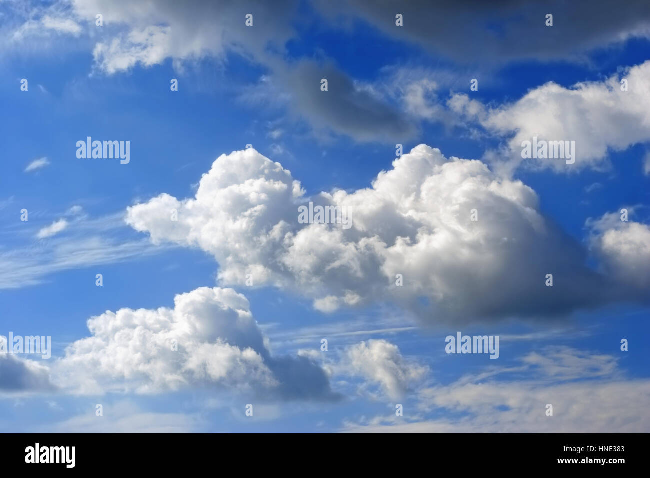 puffy clouds in a blue sky Stock Photo - Alamy