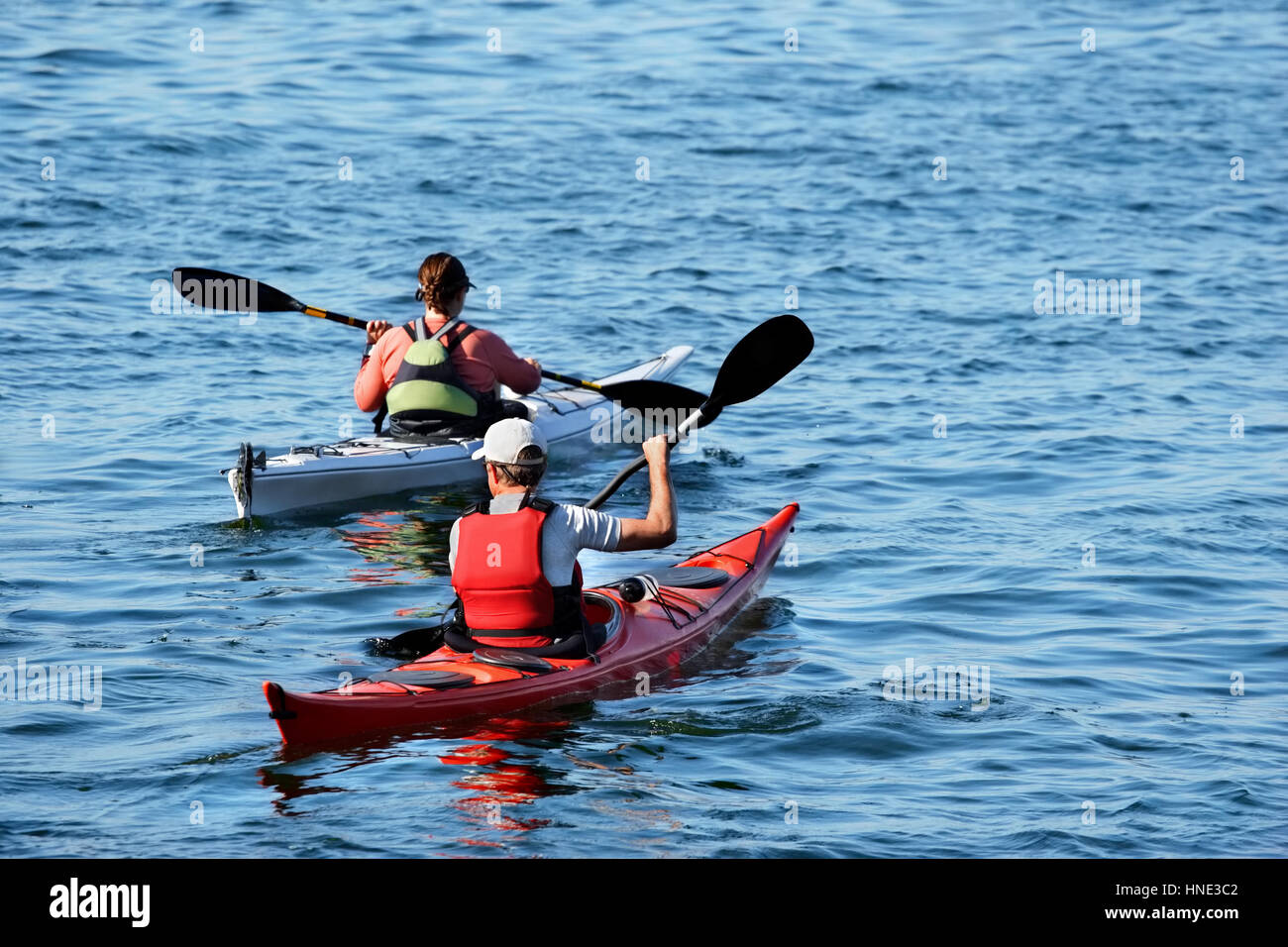 two men in kayaks on a lake Stock Photo Alamy
