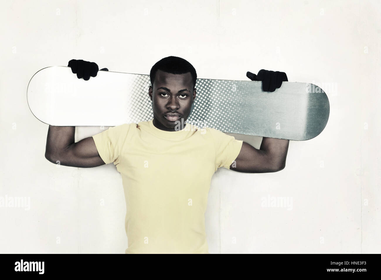 Snowboarder holding his snowboard on his shoulders Stock Photo - Alamy