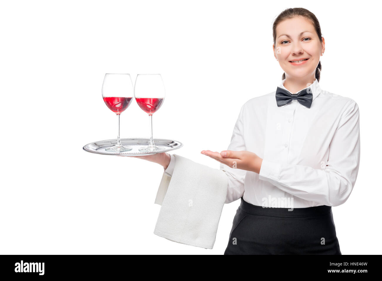 Happy waiter with glasses of wine on a tray welcomes visitors Stock Photo