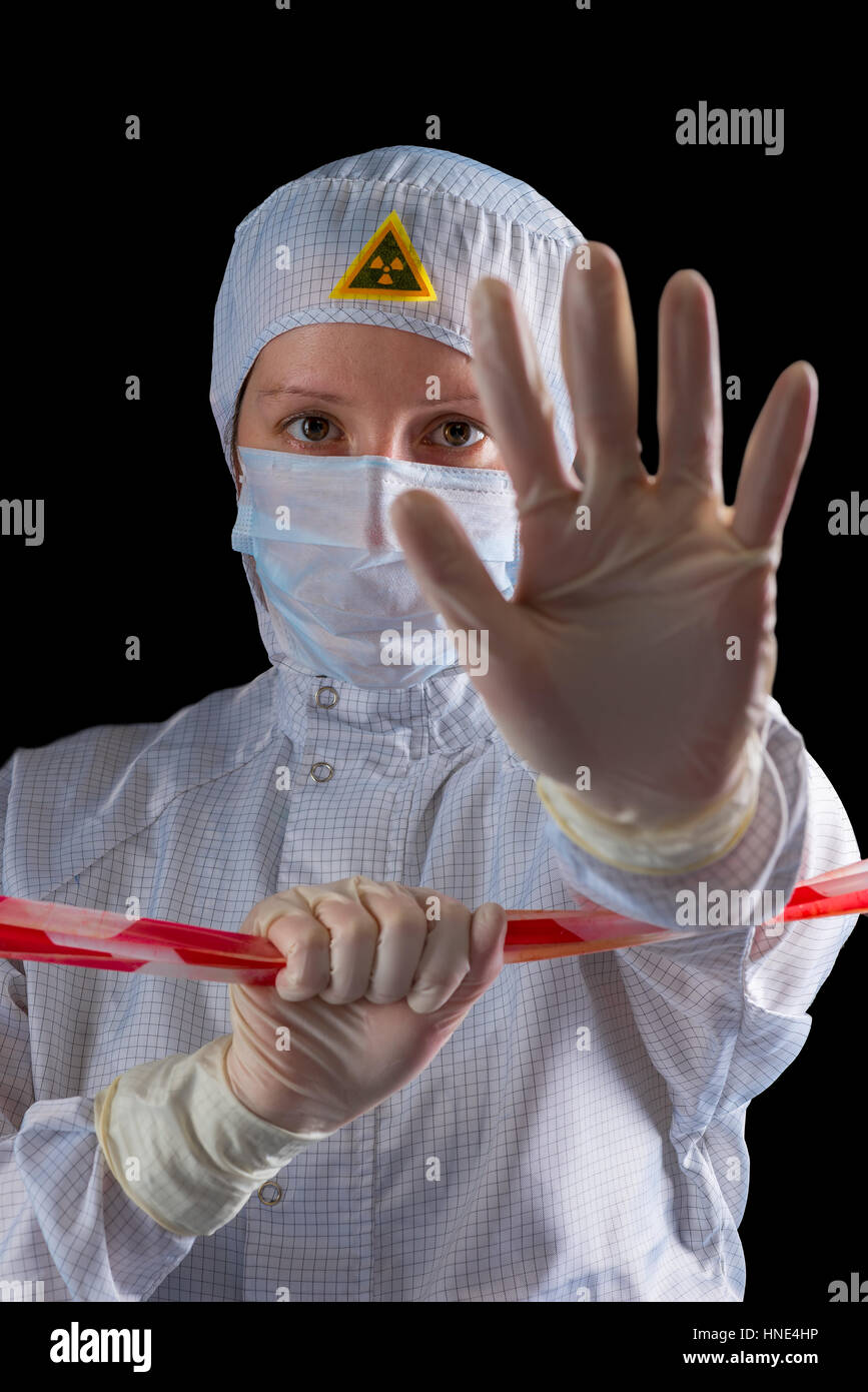 Woman working in the danger zone of radioactive contamination Stock Photo