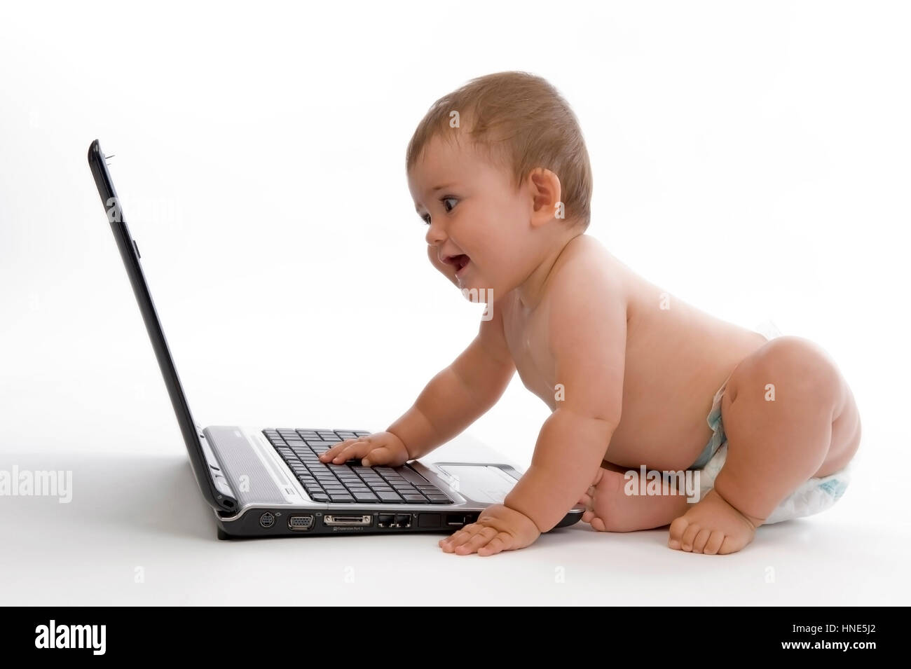 Model release, Kleinkind, 8 Monate, arbeitet am Laptop - little child using laptop Stock Photo