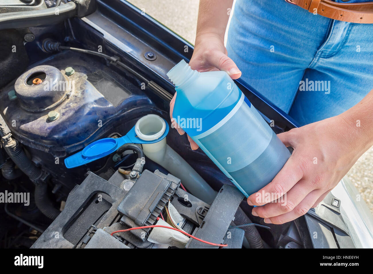 Woman filling car reservoir with windshield wiper fluid Stock Photo Alamy