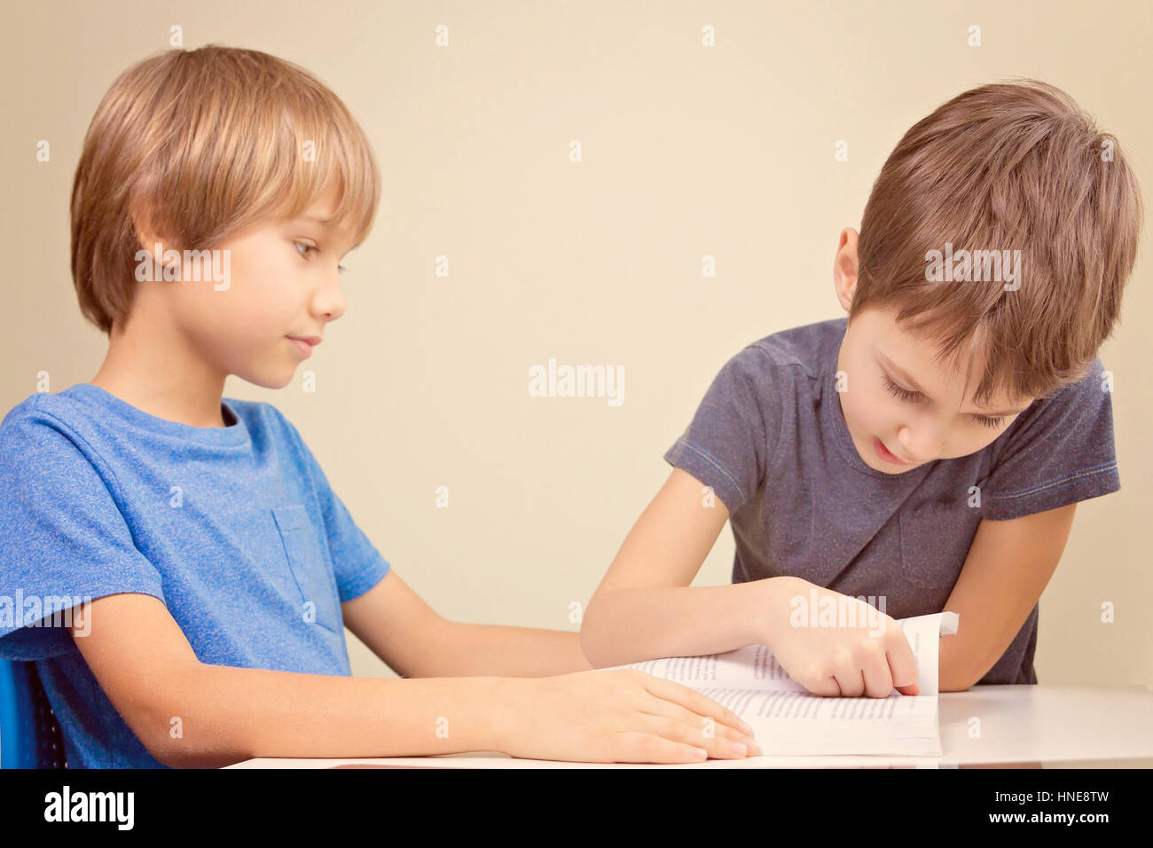 Kids reading a book. Little boy practice reading with his brother at ...