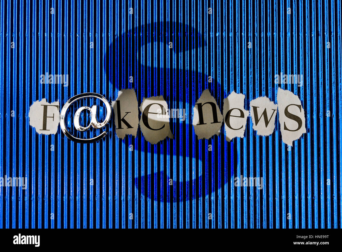 Stroke Fake news with at-sign and section sign, jurisdiction by the spreading of false alarms, Schriftzug Fake News mit At-Zeichen und Paragraphenzeic Stock Photo