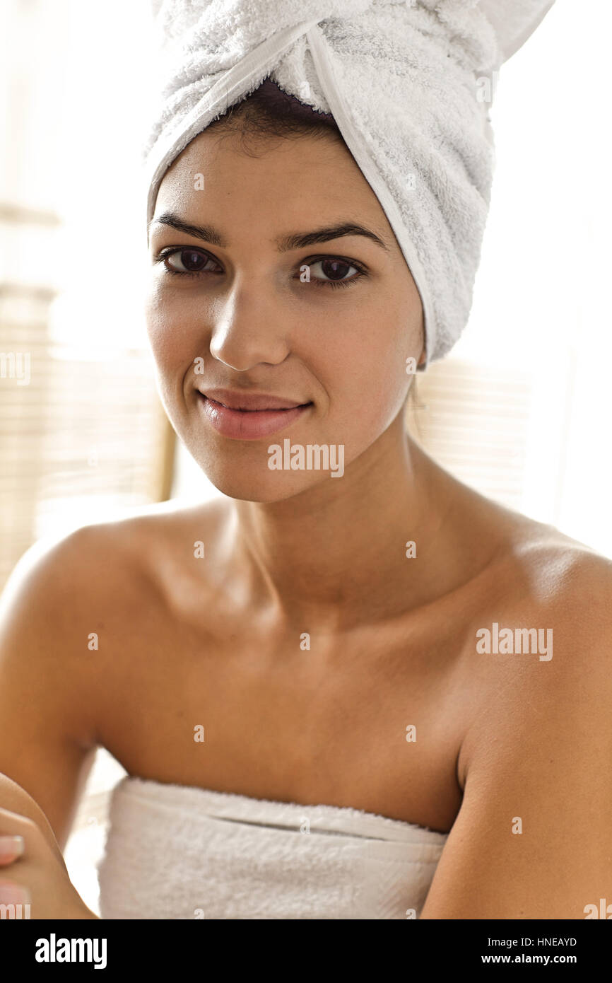 Portrait of young woman wrapped in towel Stock Photo - Alamy