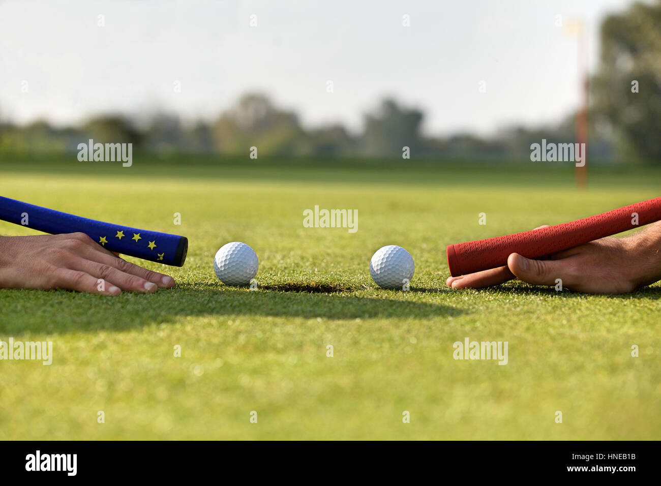 Human hands using golf balls to play pool Stock Photo