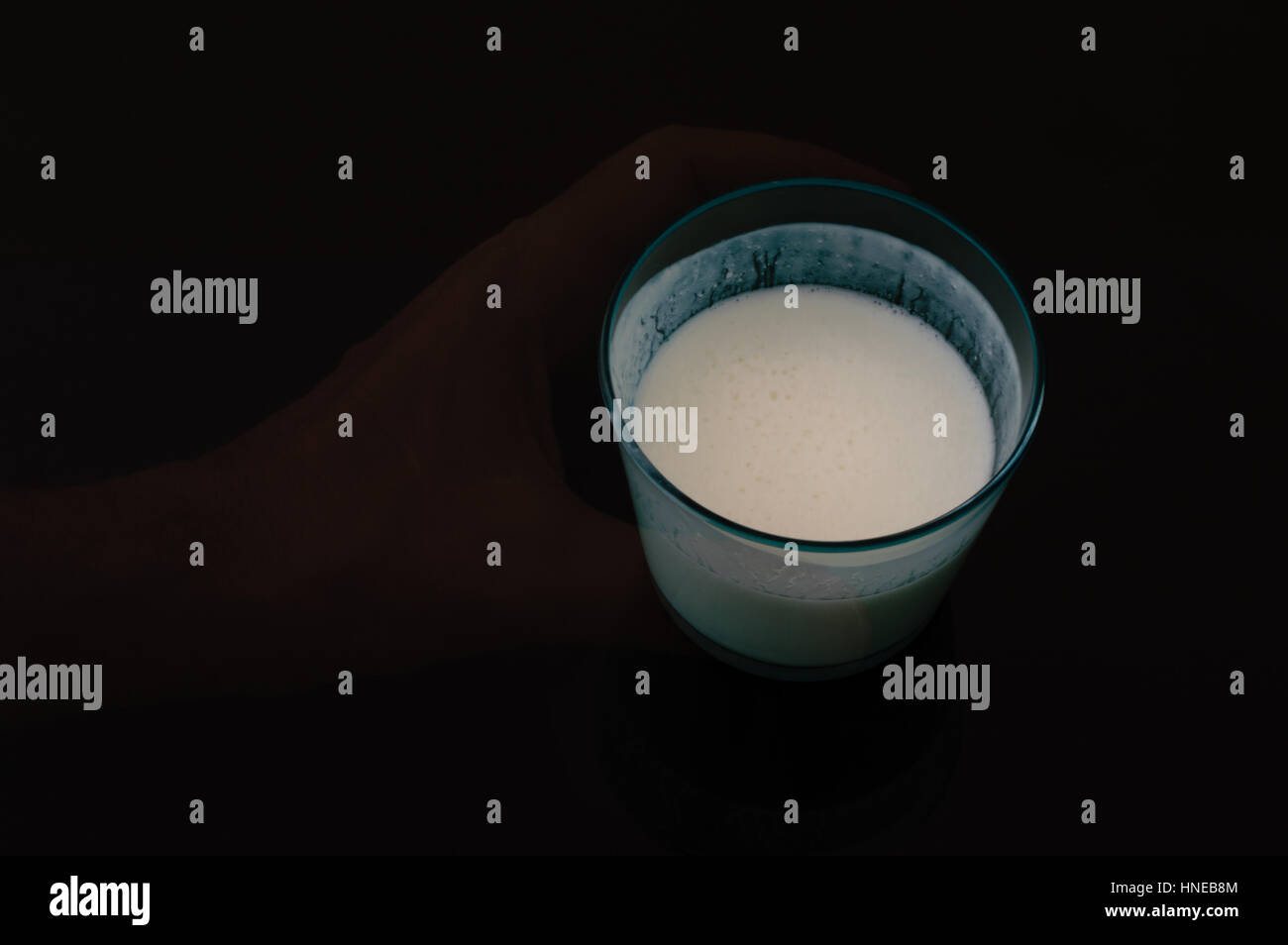 Ghost hand holding a glass of kefir Stock Photo