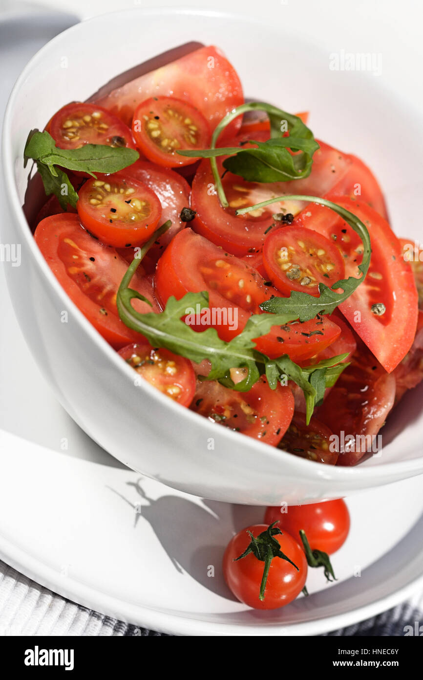 Close  - up of sliced tomatoes with rucola Stock Photo