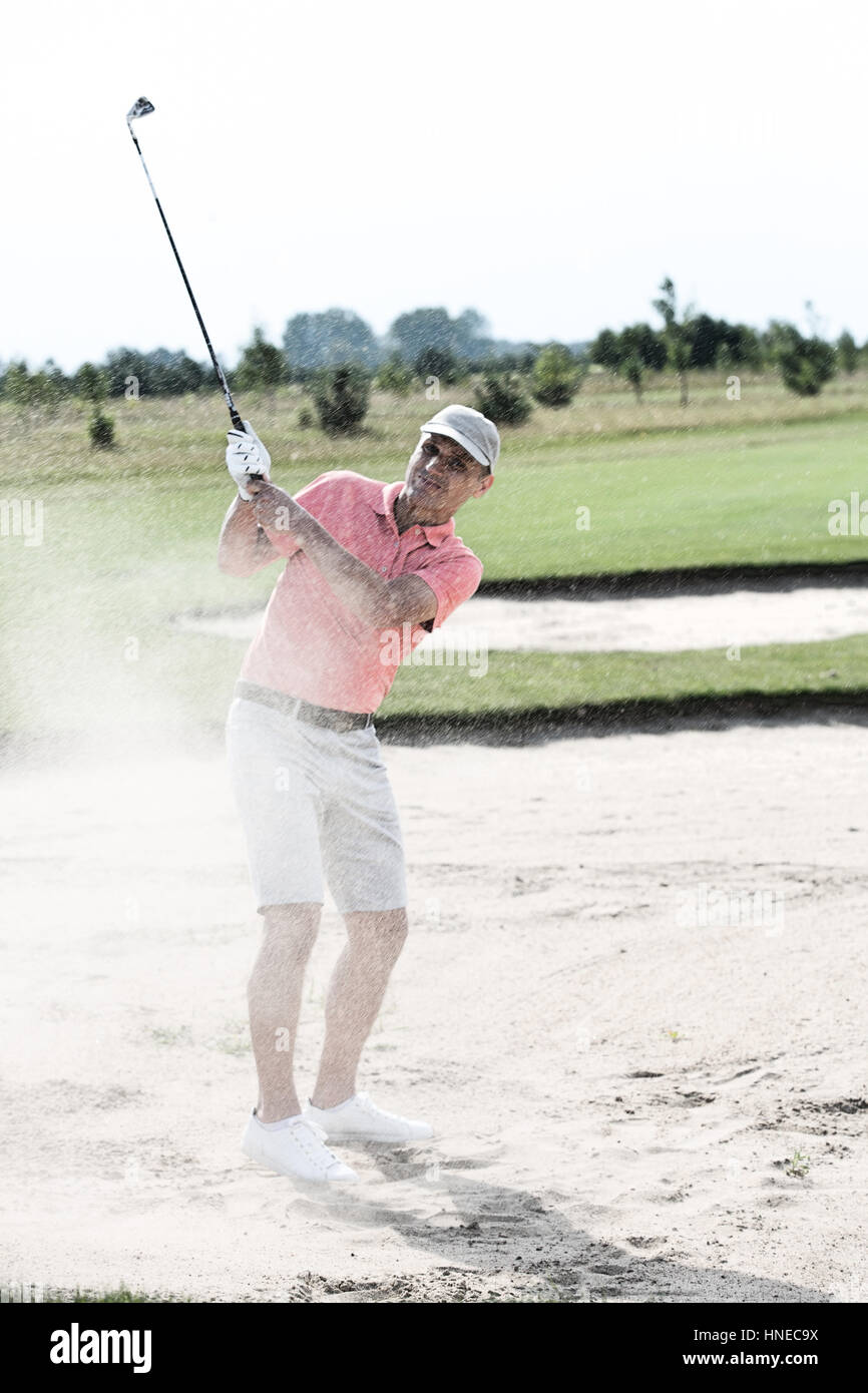 Middle-aged man playing at golf course Stock Photo