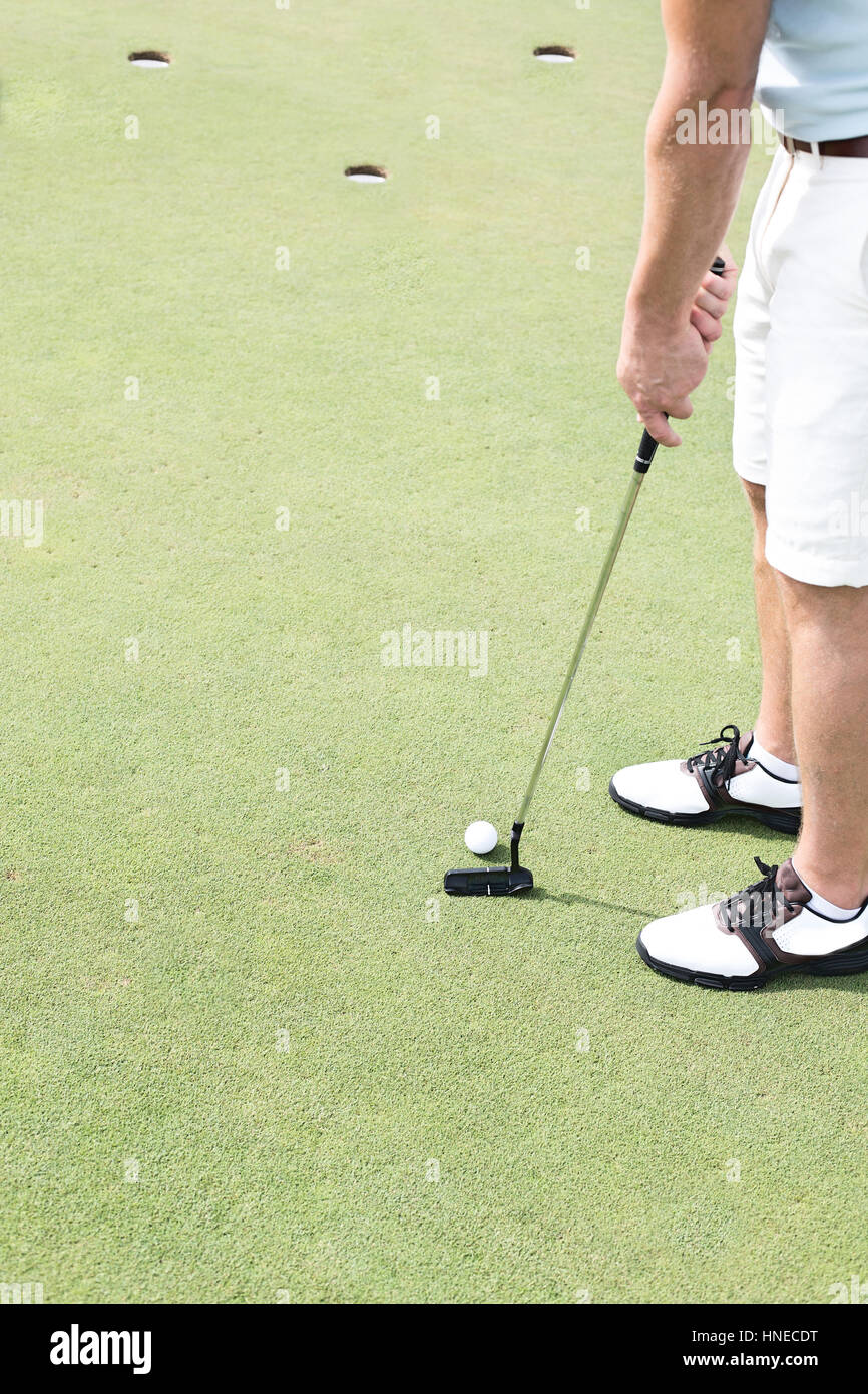 Low section of mid-adult man playing golf Stock Photo