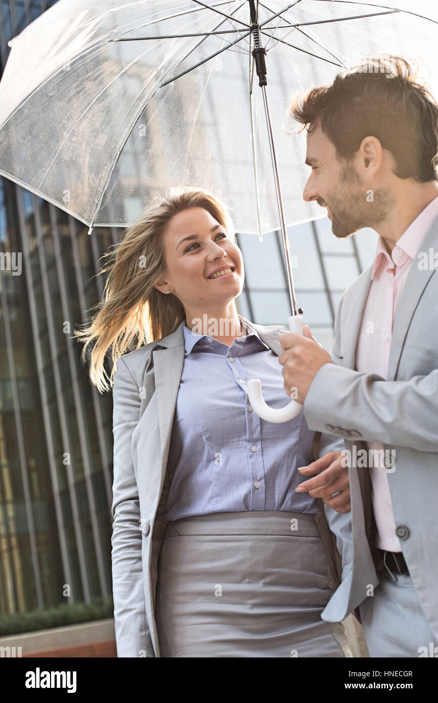 Man woman standing under umbrella hi-res stock photography and images ...