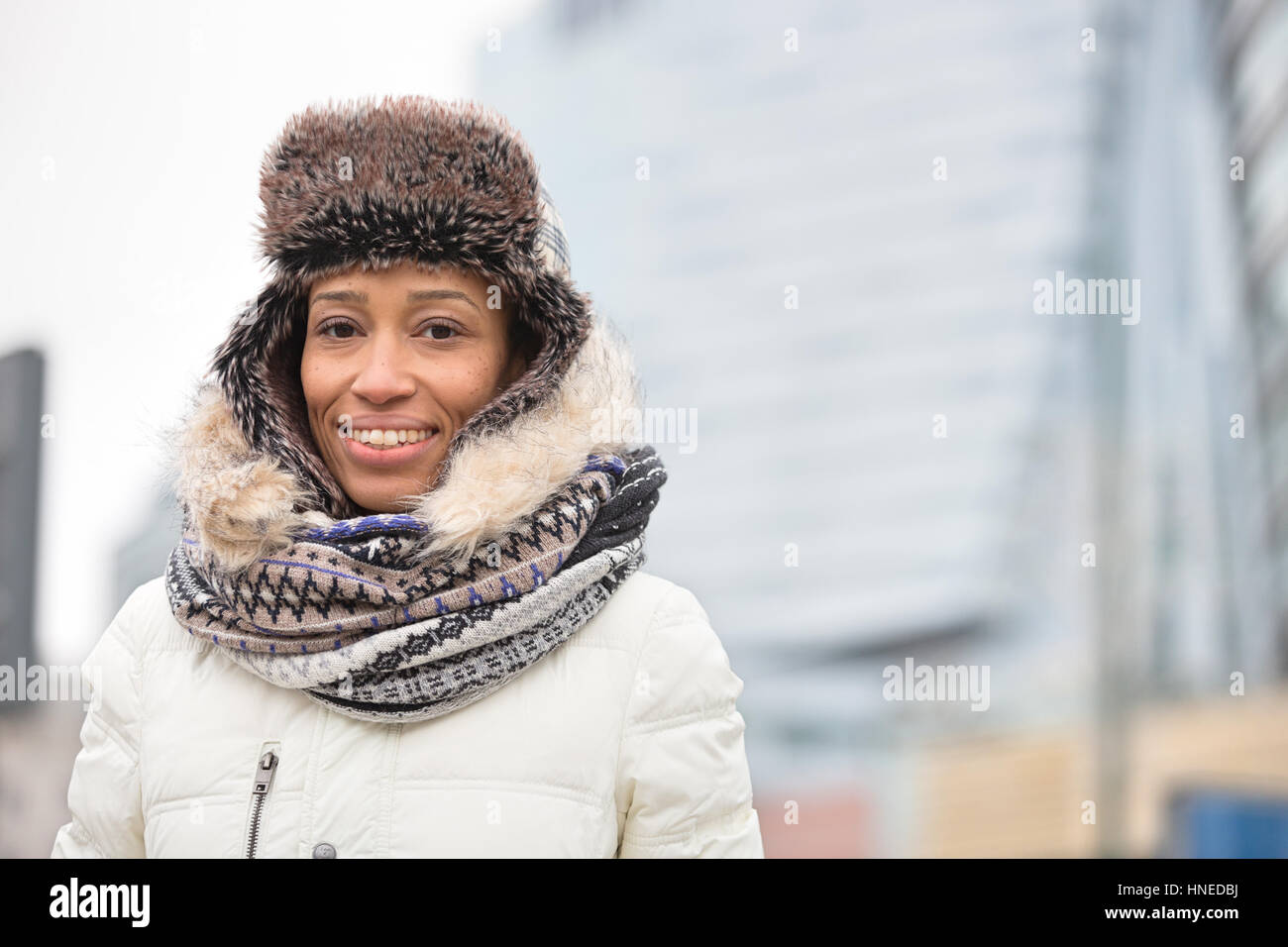 Portrait of happy woman in warm clothing outdoors Stock Photo