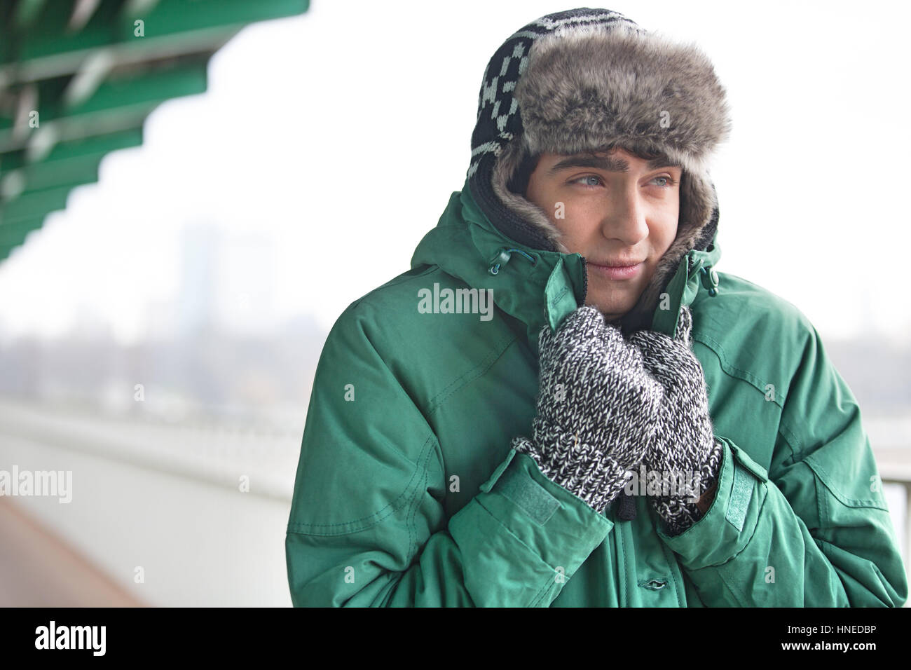 Man in warm clothing shivering outdoors Stock Photo