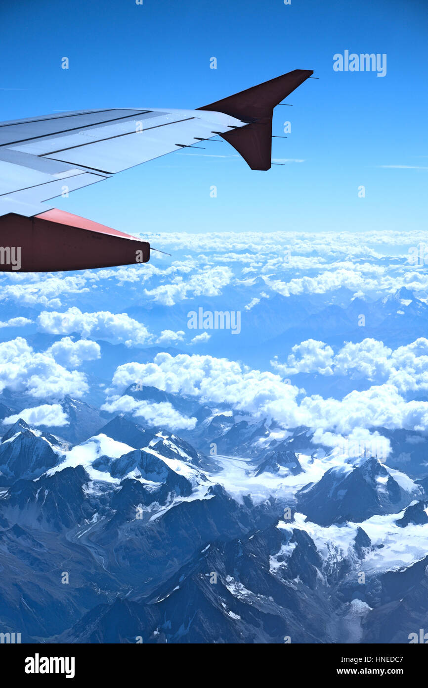 View from the plane over snowy mountains Stock Photo