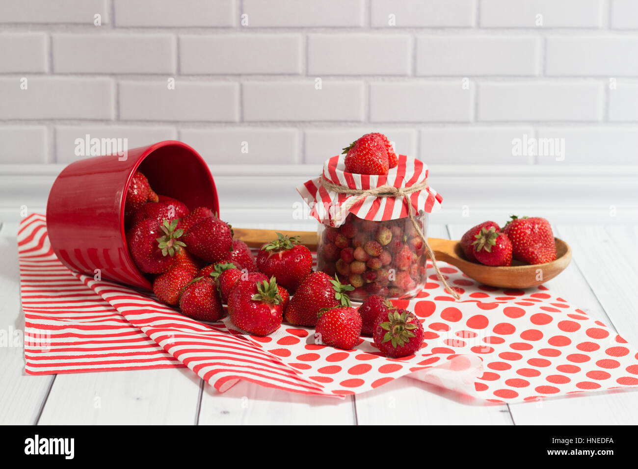 Delicious strawberry in jar and red pot Stock Photo