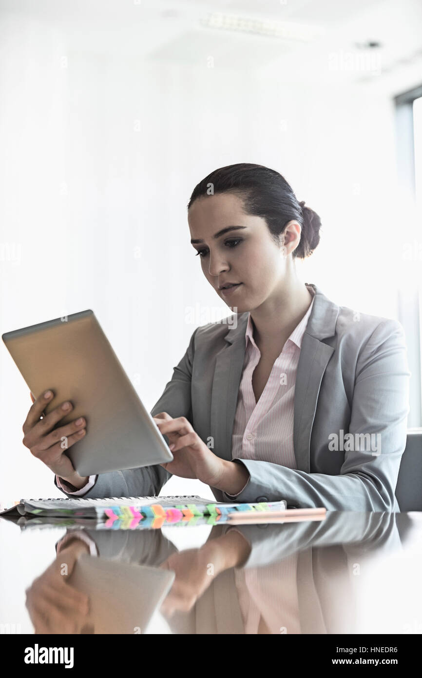 Young businesswoman using tablet PC in office Stock Photo
