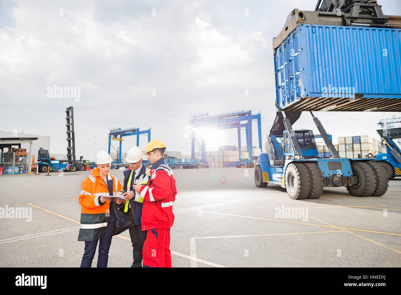 Workers discussing in shipping yard Stock Photo