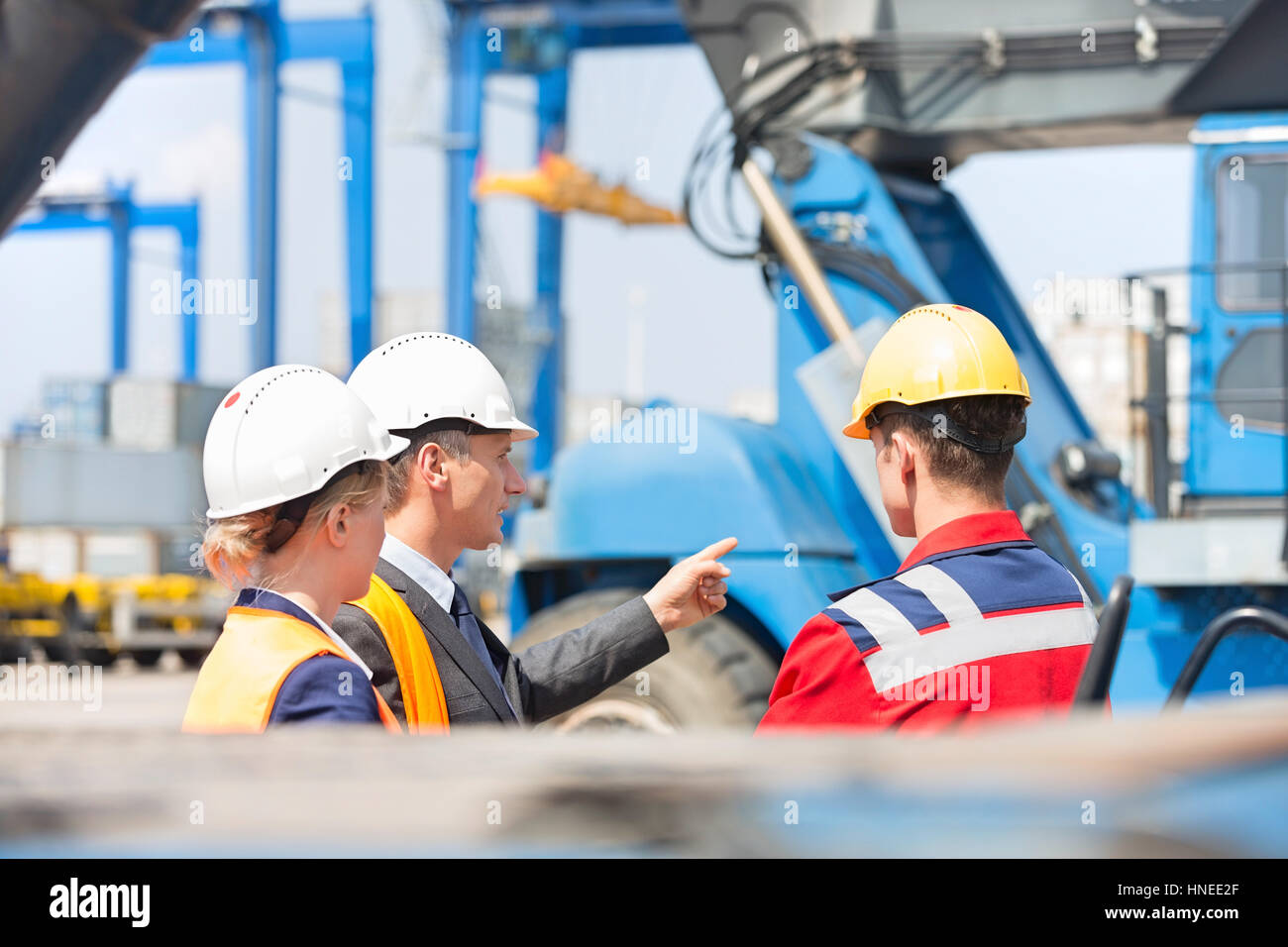 Workers discussing in shipping yard Stock Photo