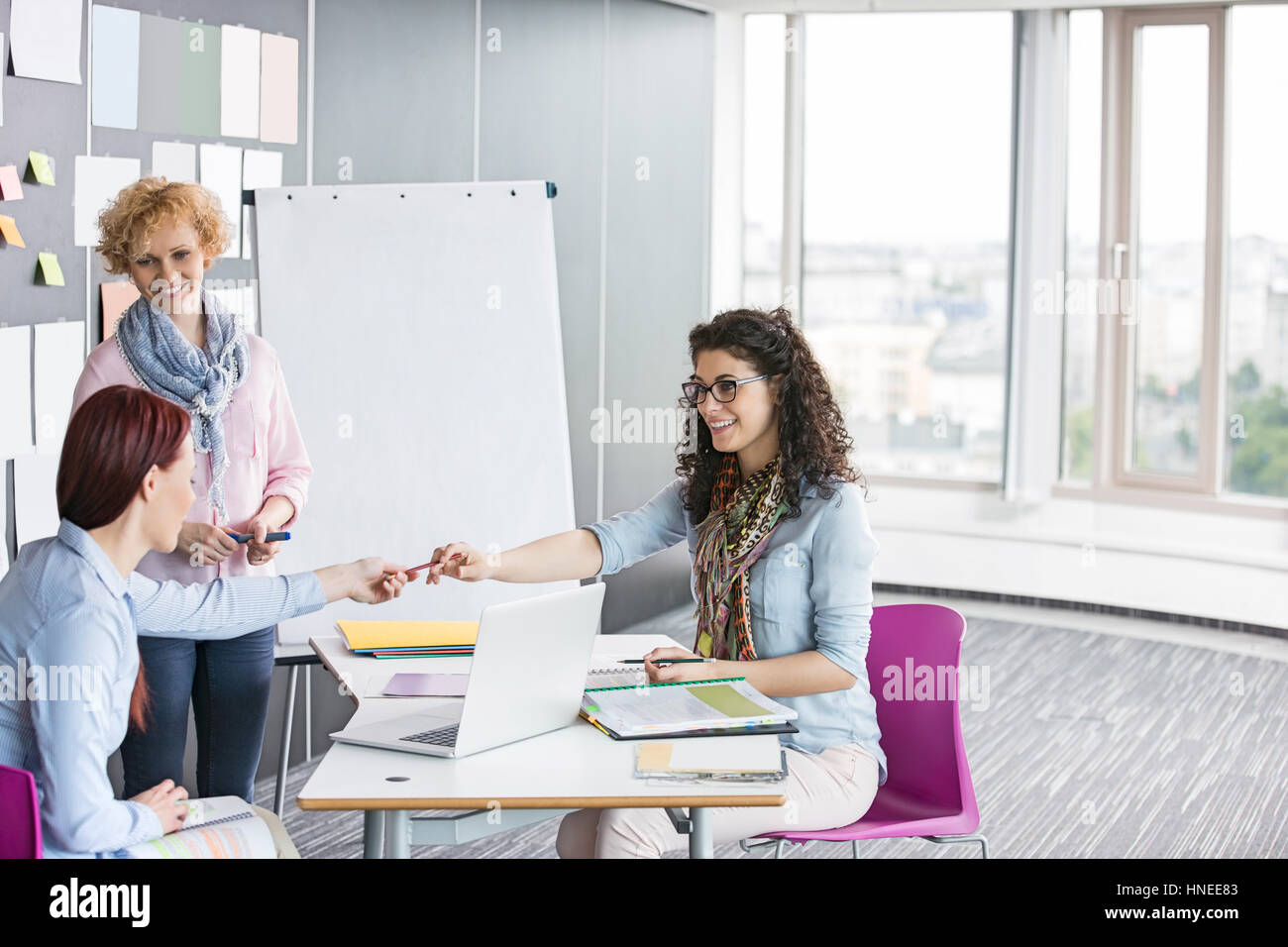 Businesswomen working together in creative office Stock Photo