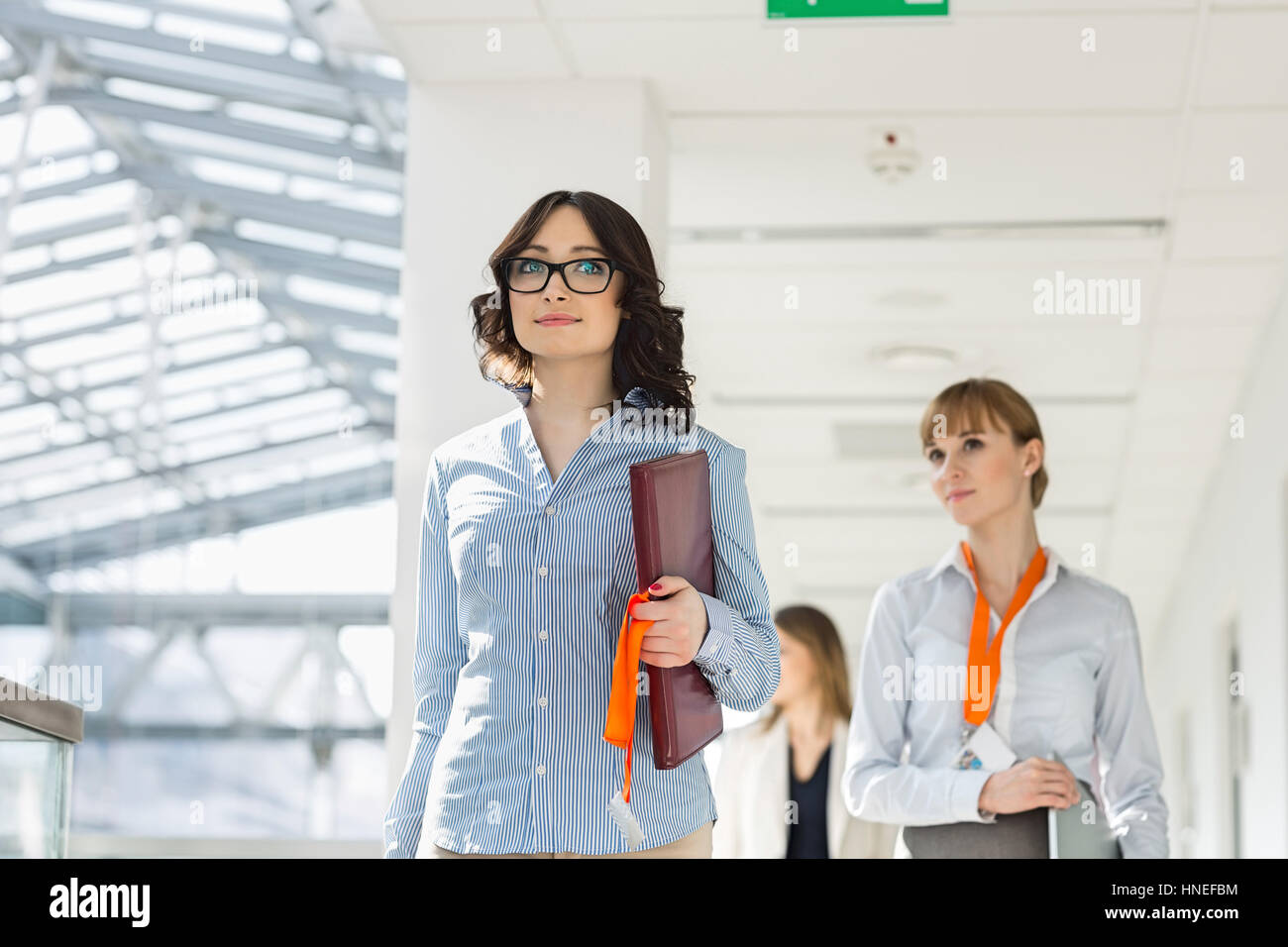 Businesswomen walking at office Stock Photo