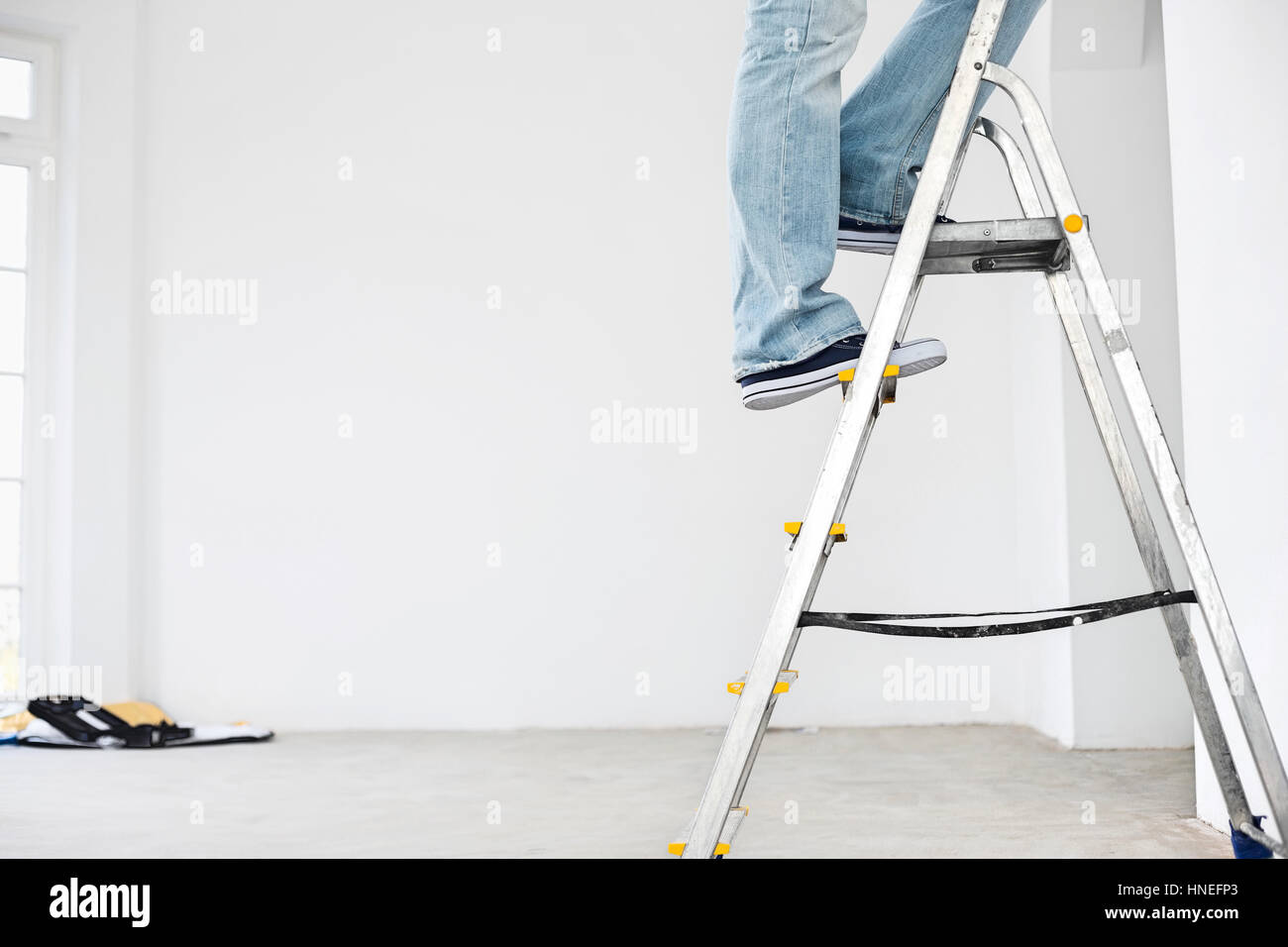 Low section of man on ladder Stock Photo
